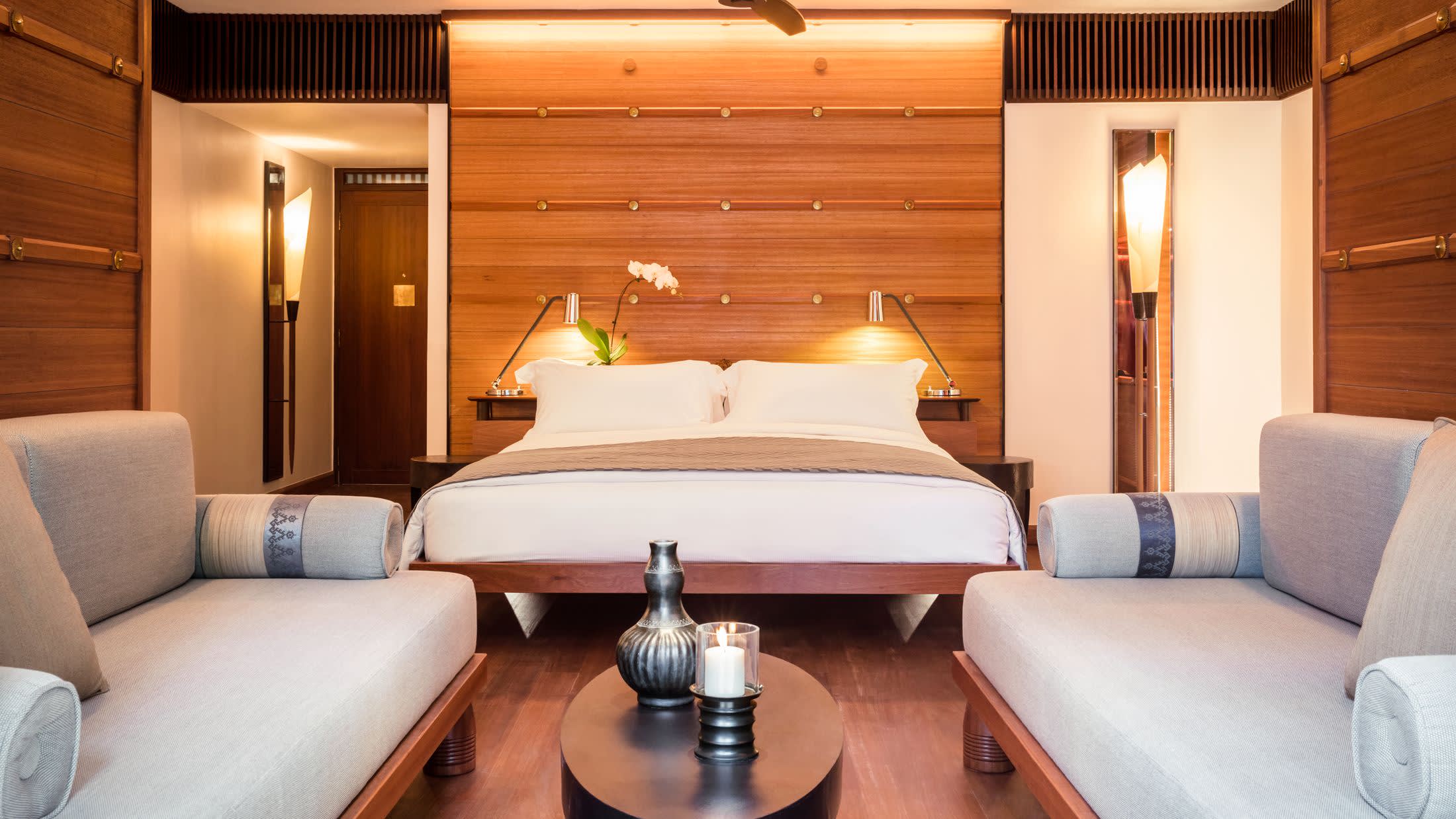 a bedroom with a bed and a mirror