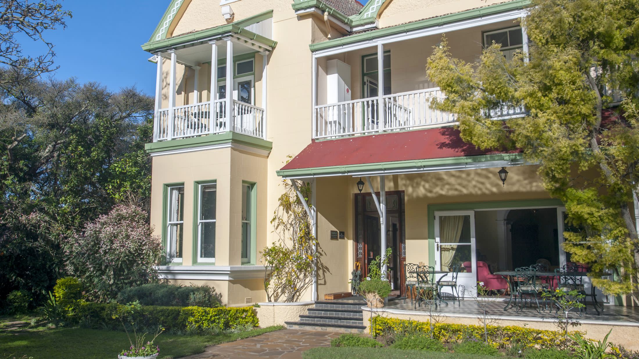 a house with trees in front of a building