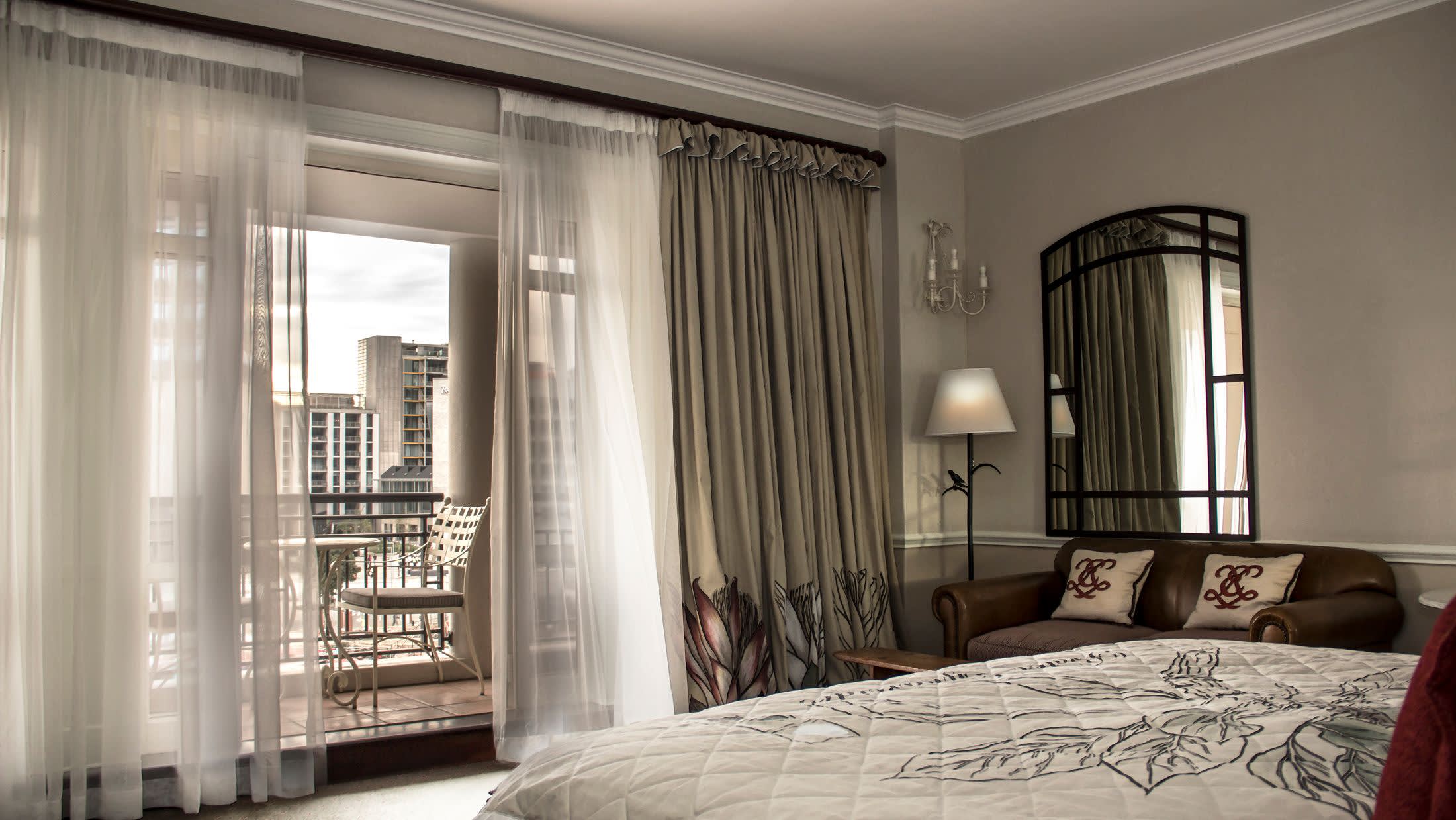 a bedroom with a bed and a large window