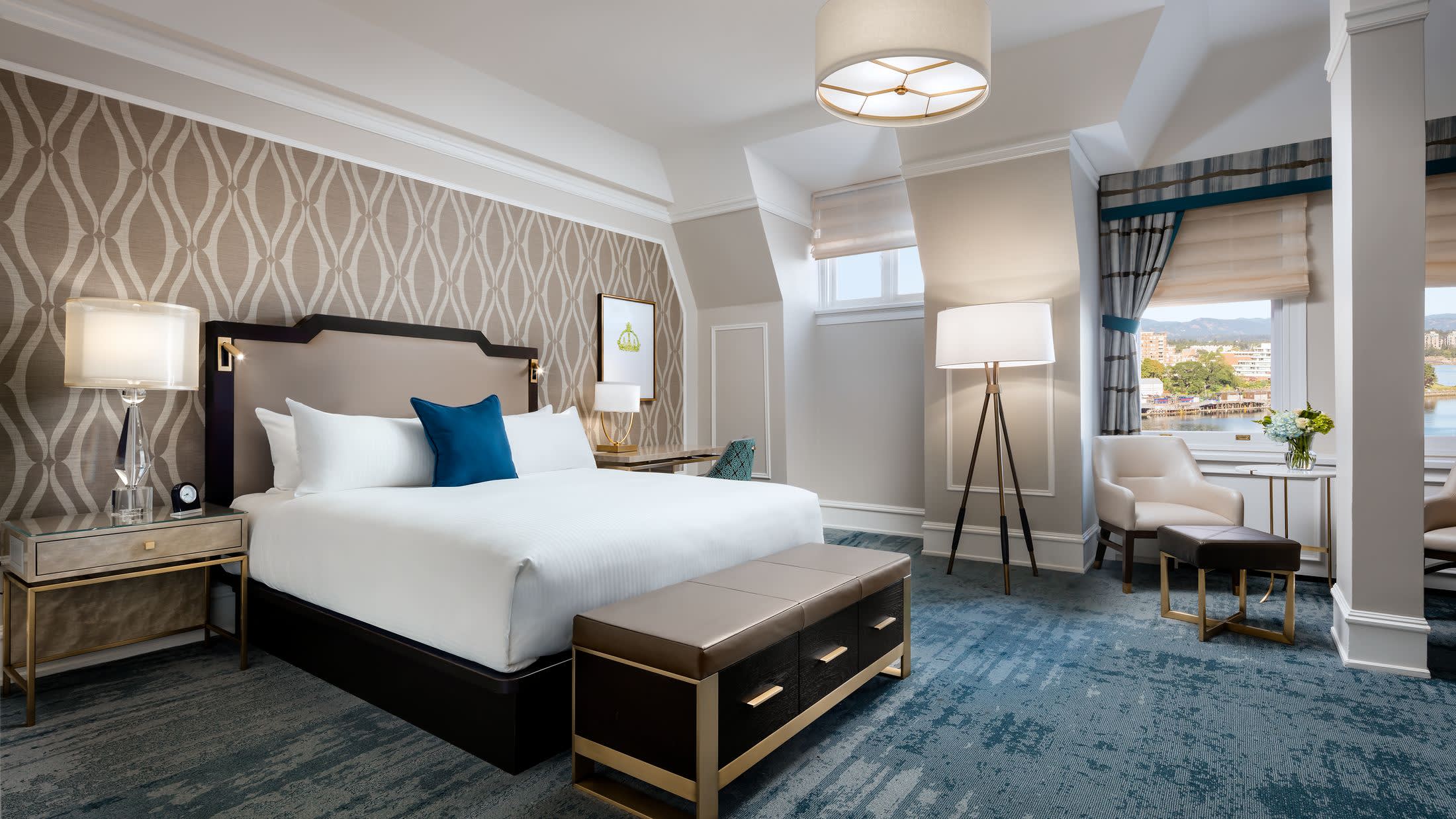 a bedroom with a bed and a chair in a room