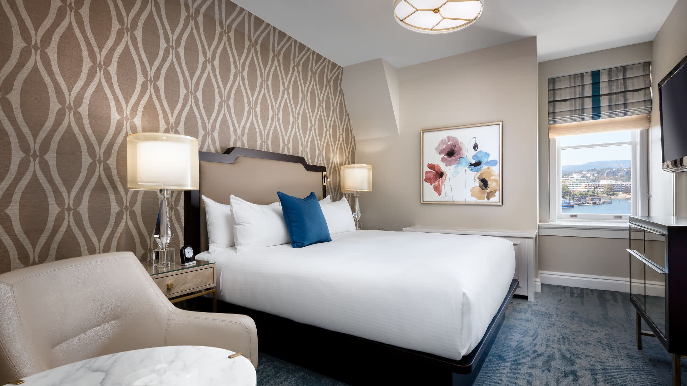 a bedroom with a bed and desk in a room