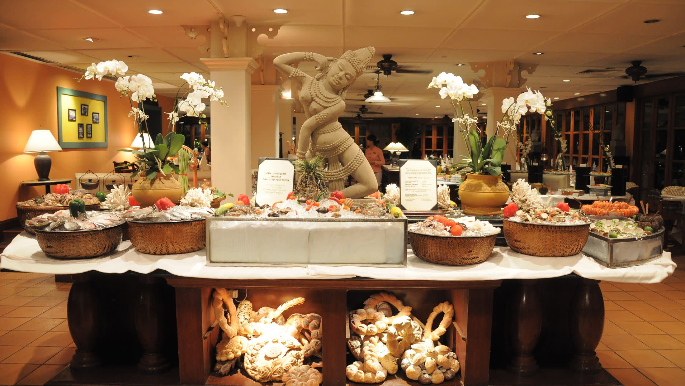 a room filled with furniture and vase of flowers on a table