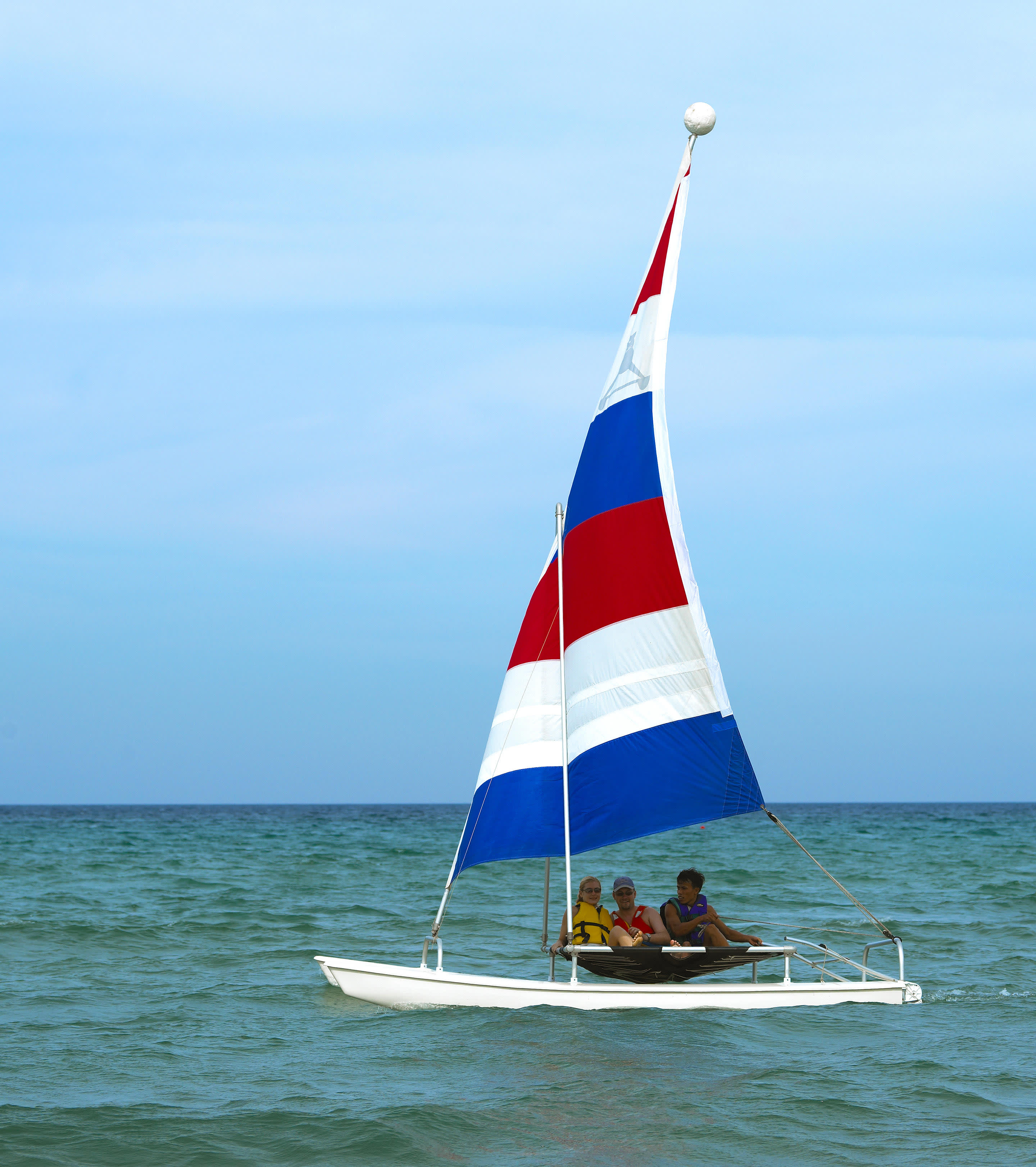 a flag on the back of a boat next to a body of water