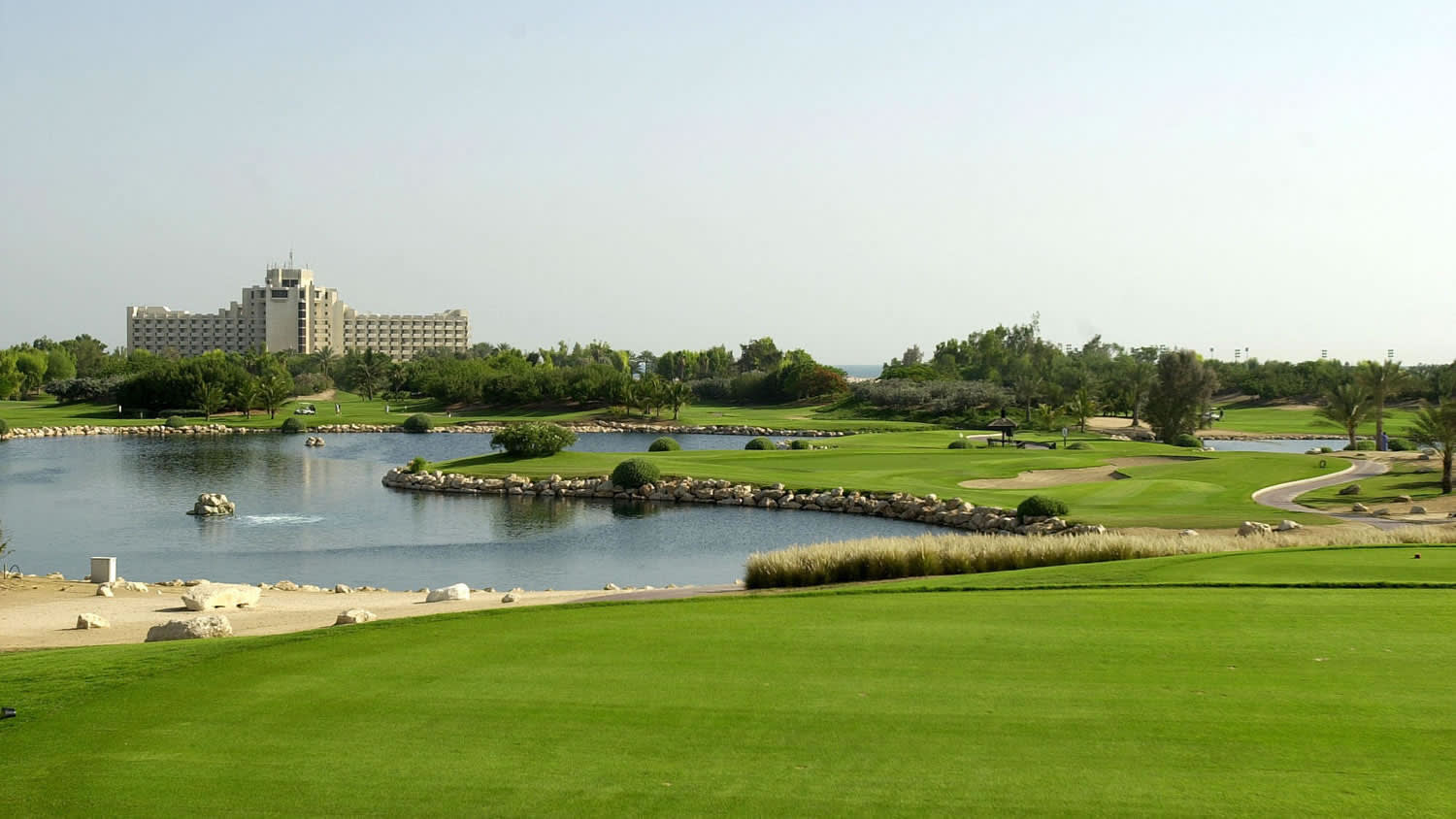 a large body of water with buildings in the background