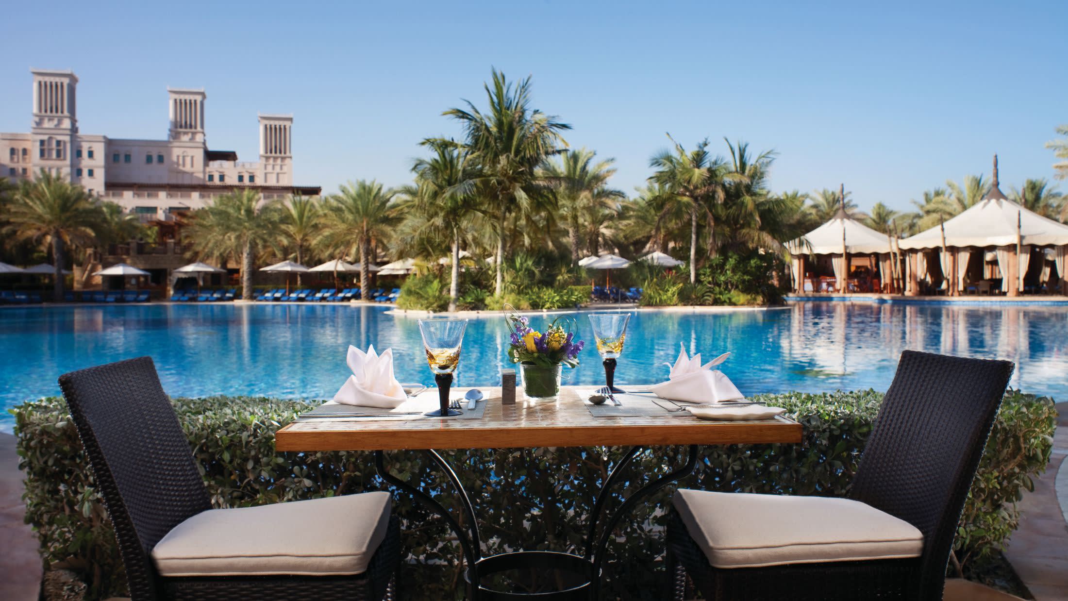 a group of lawn chairs sitting on top of a body of water