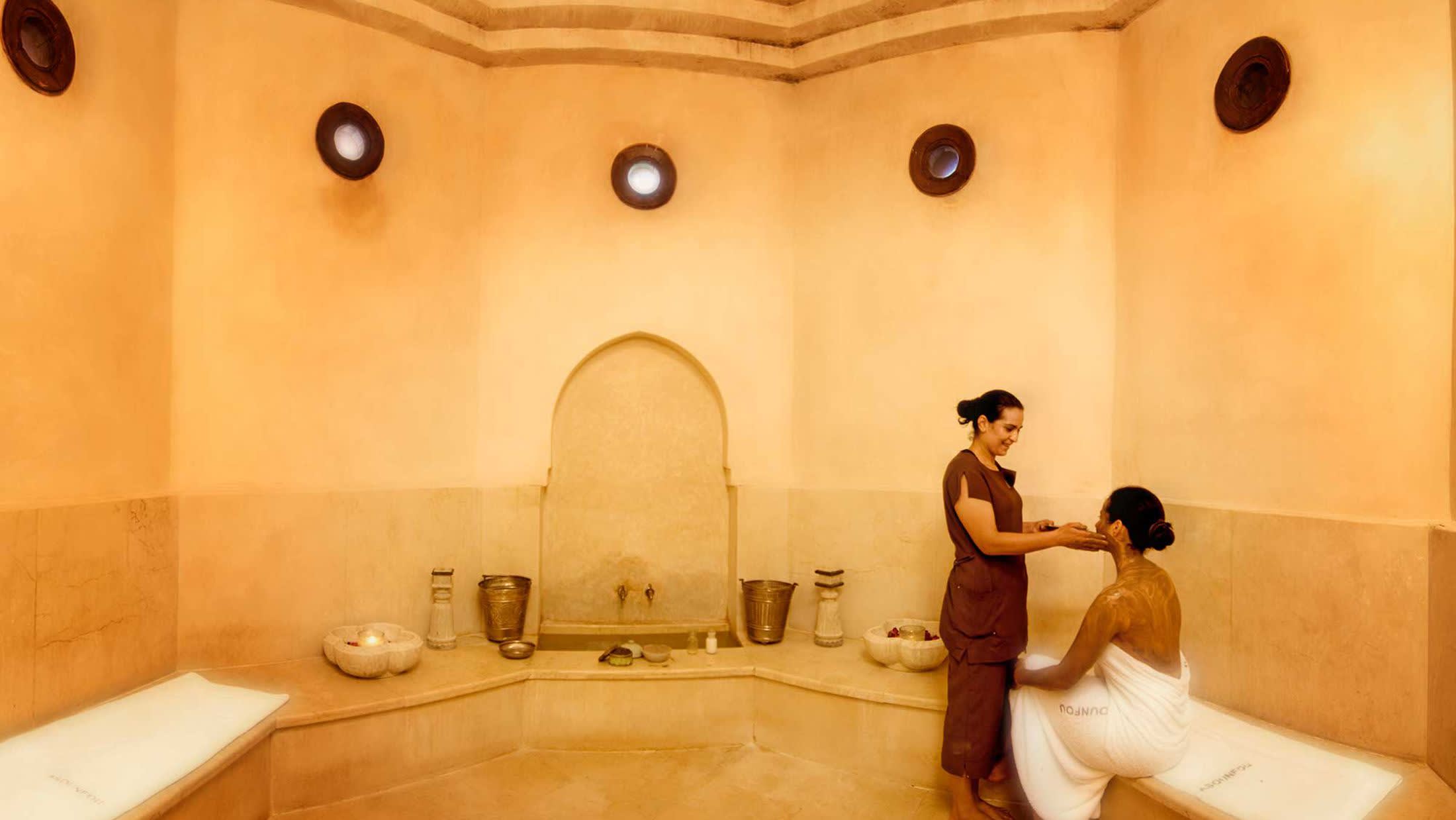 a man standing next to a sink
