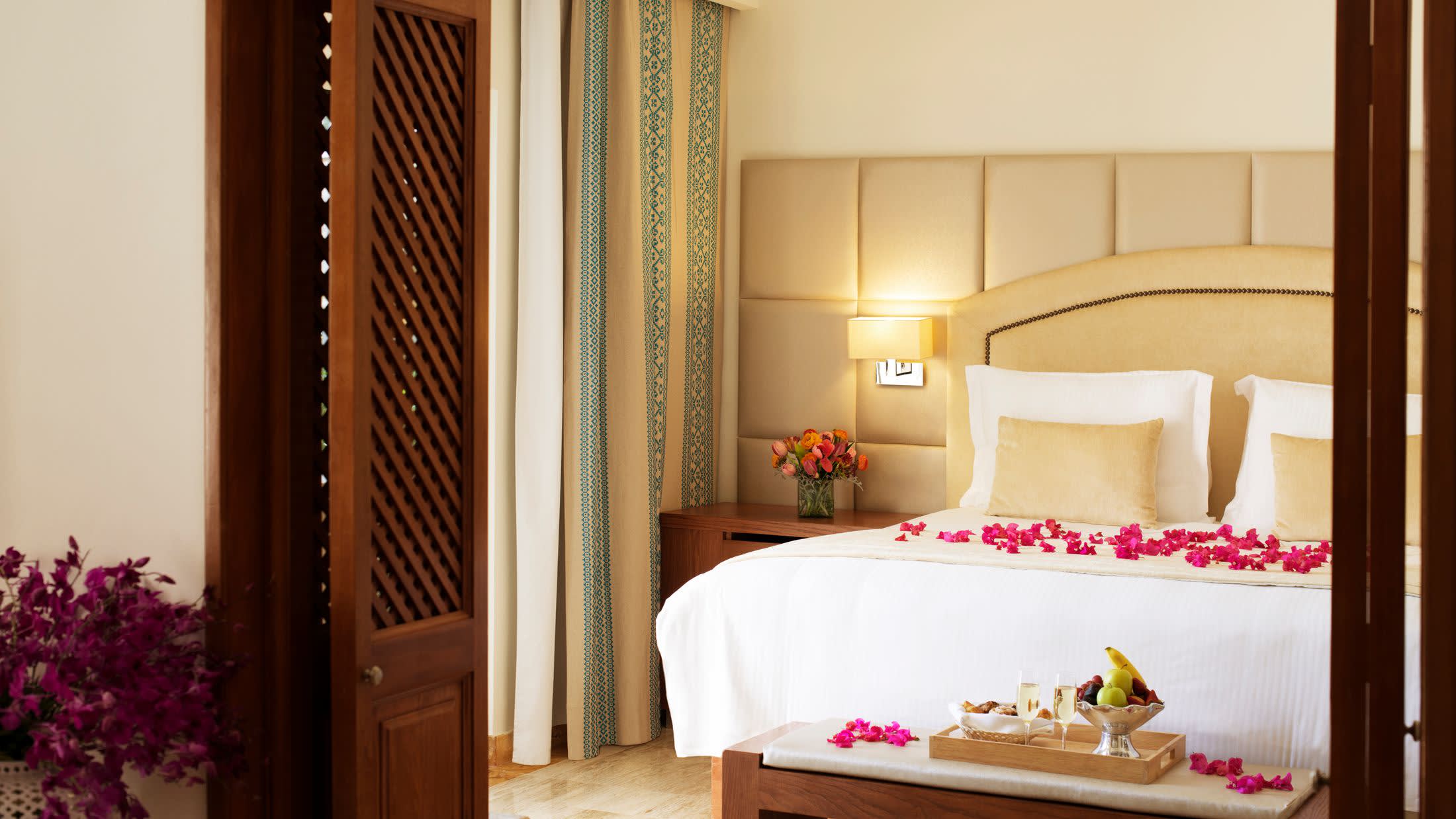 a bedroom with a bed and a table in a room