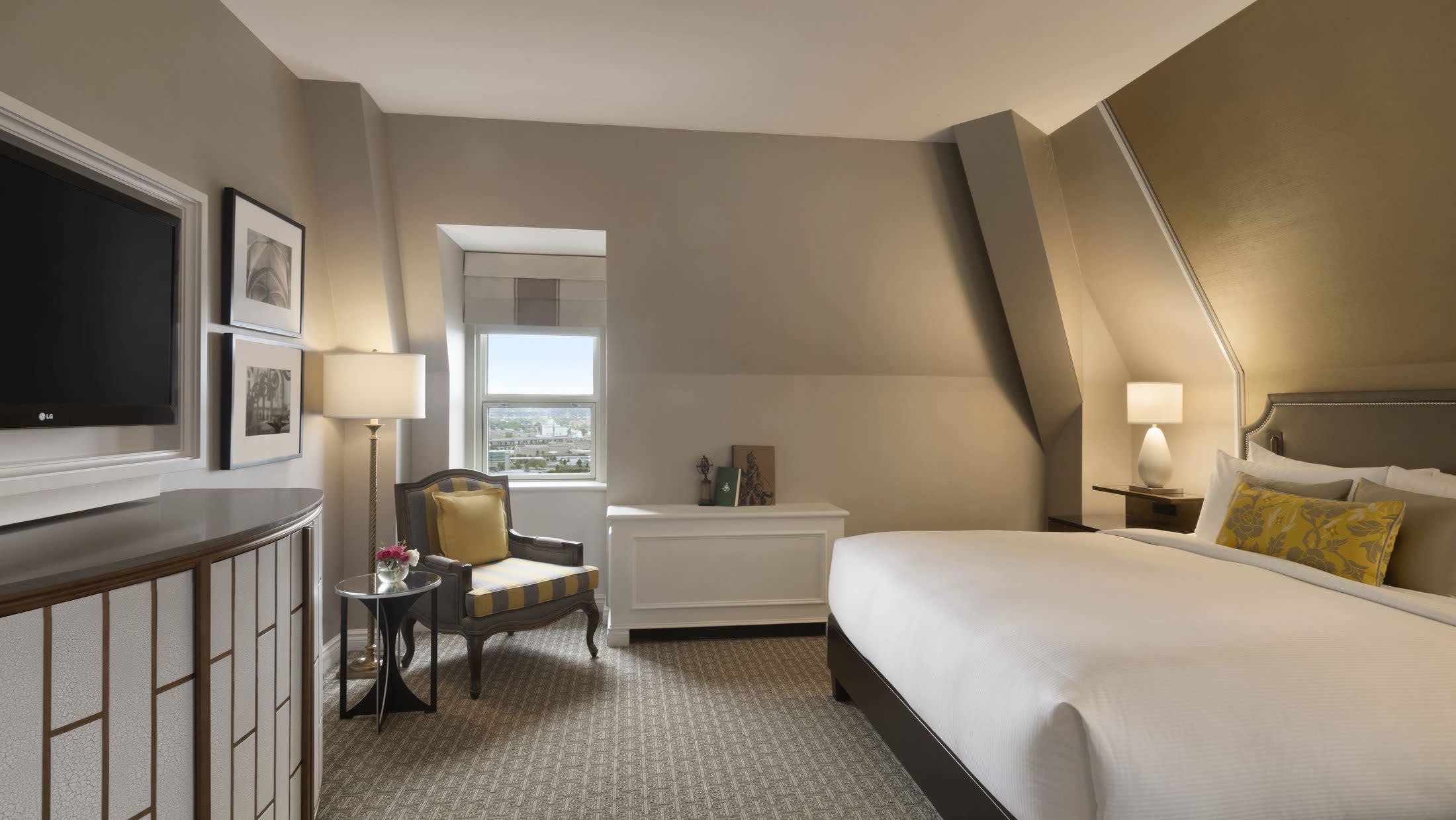 a bedroom with a bed and desk in a room