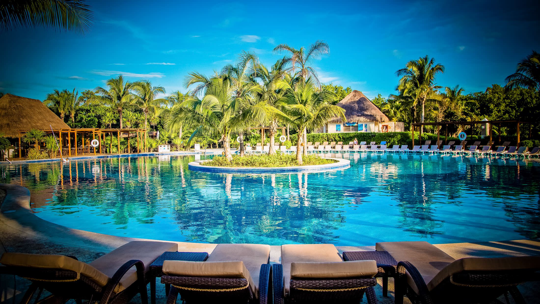 a group of lawn chairs sitting on top of a body of water