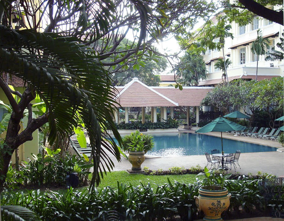 a bench next to a palm tree