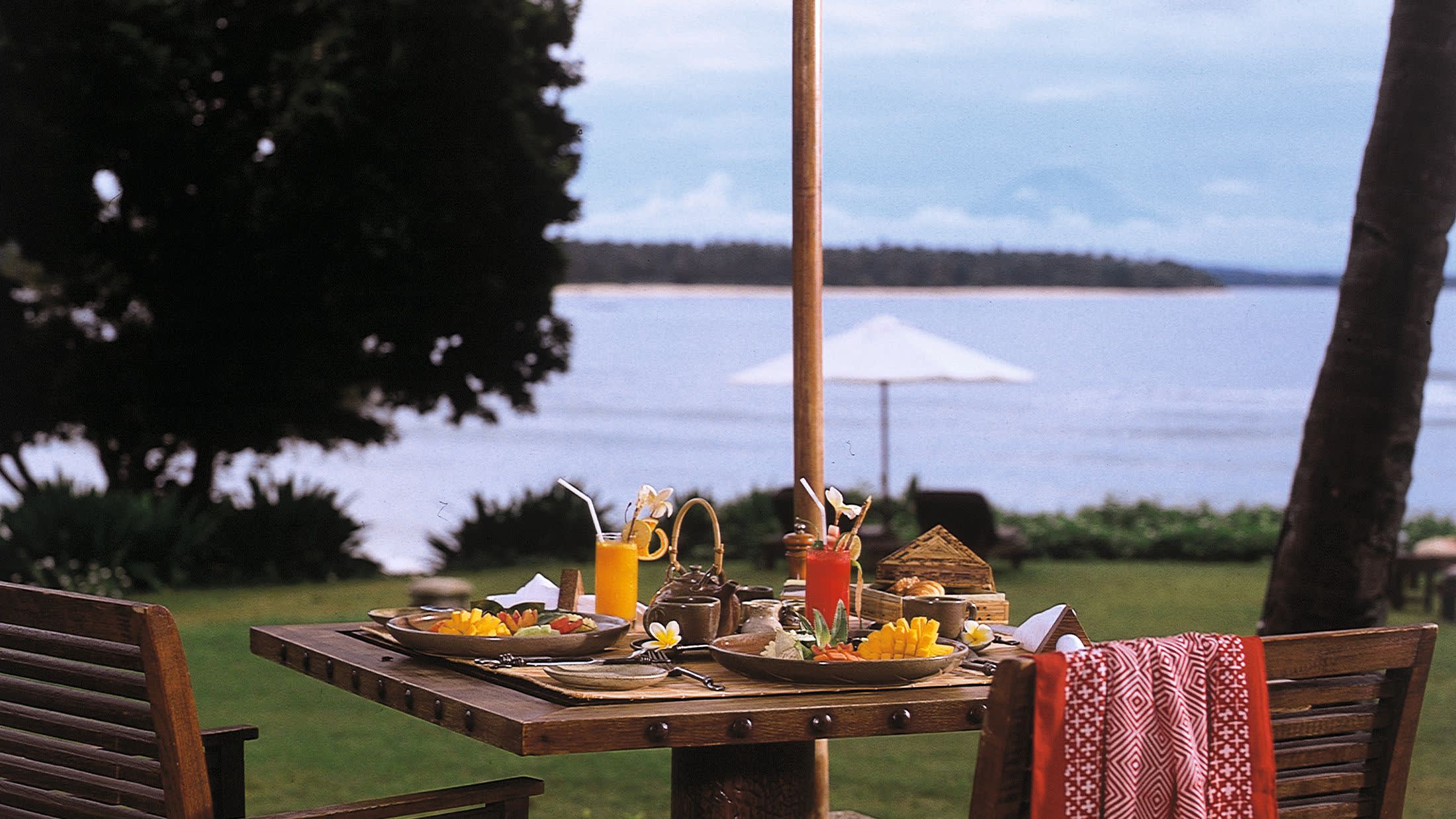 a wooden bench in front of a body of water