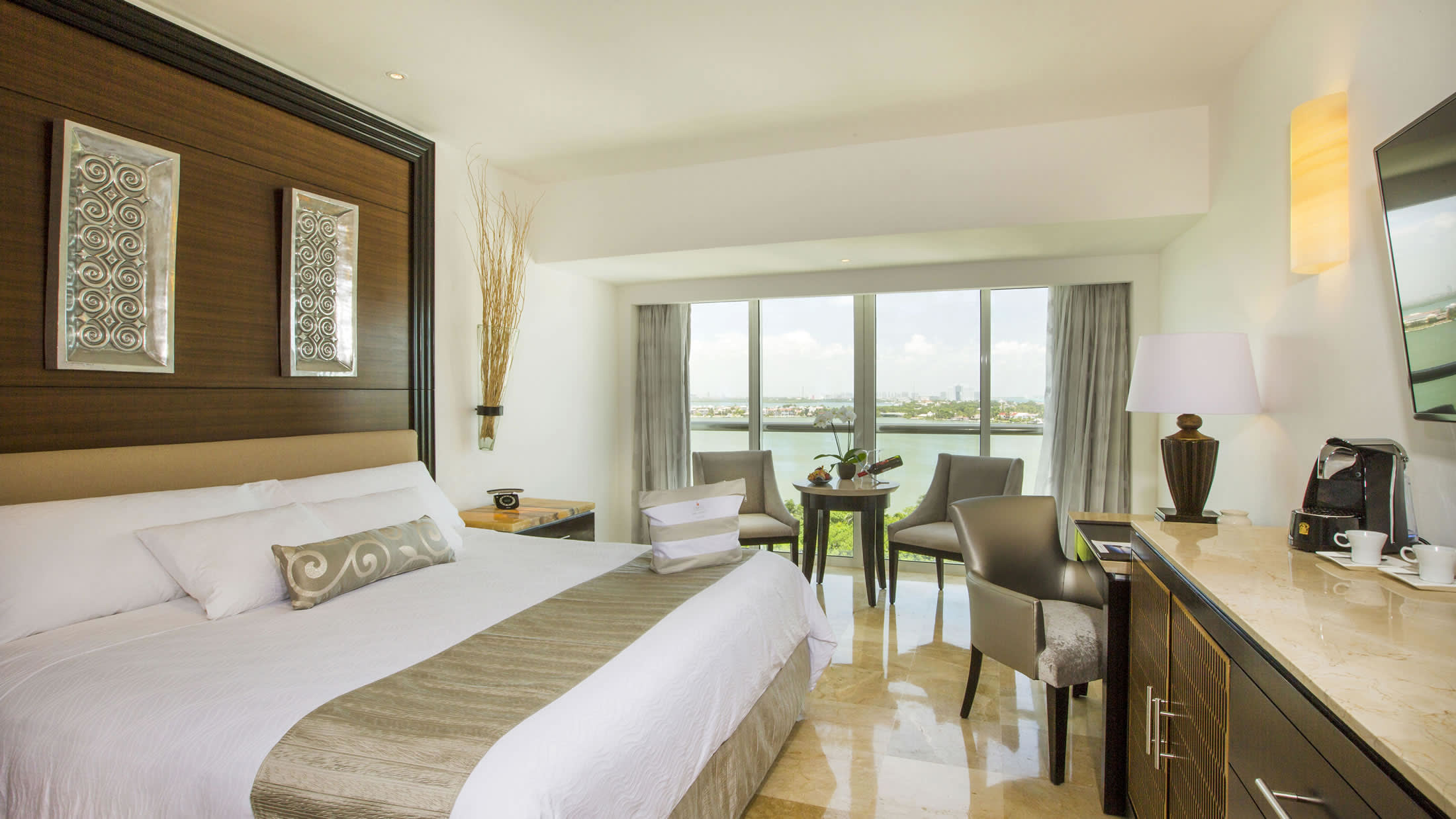 a bedroom with a large bed in a hotel room