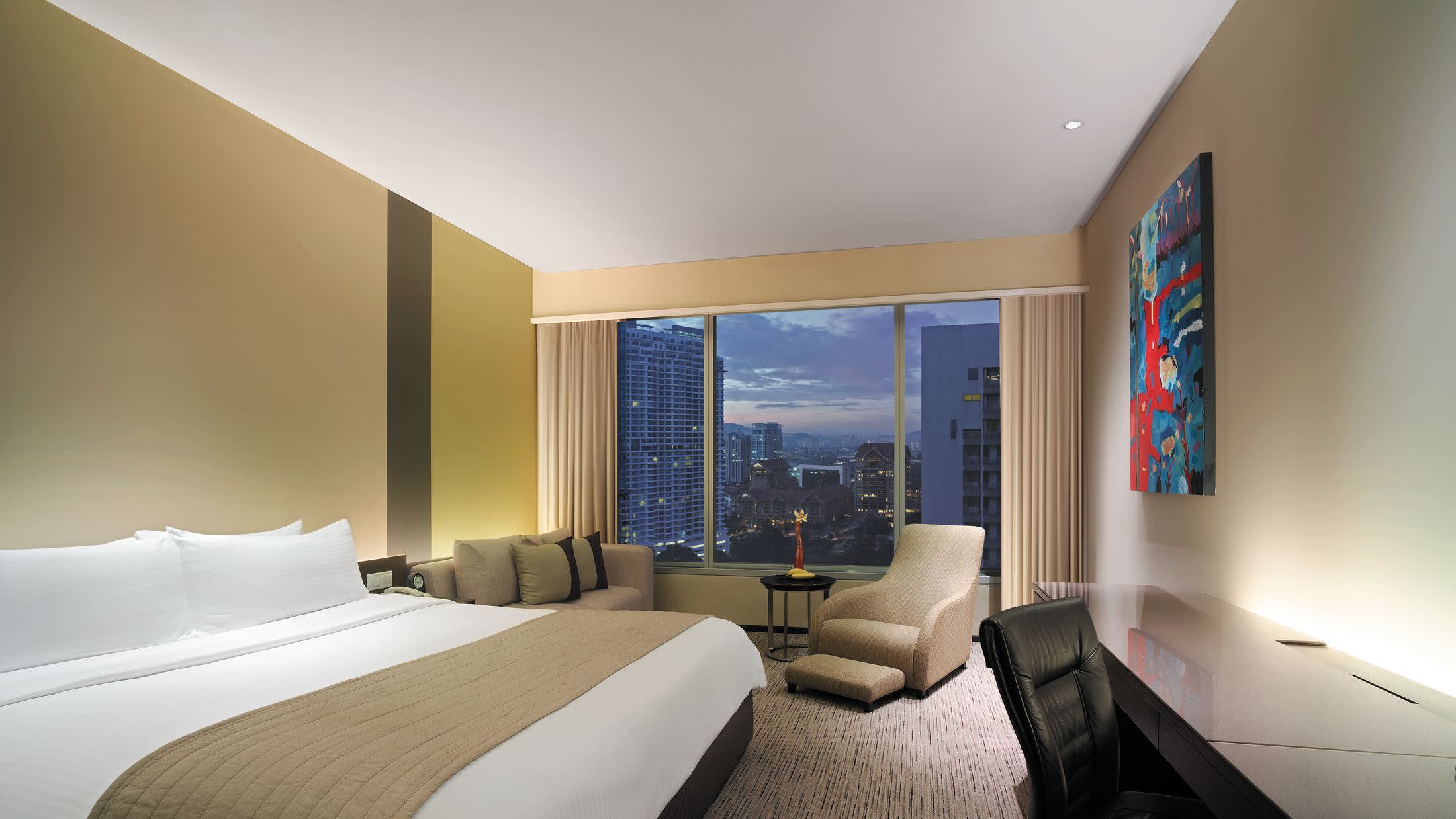 a bedroom with a large bed in a hotel room