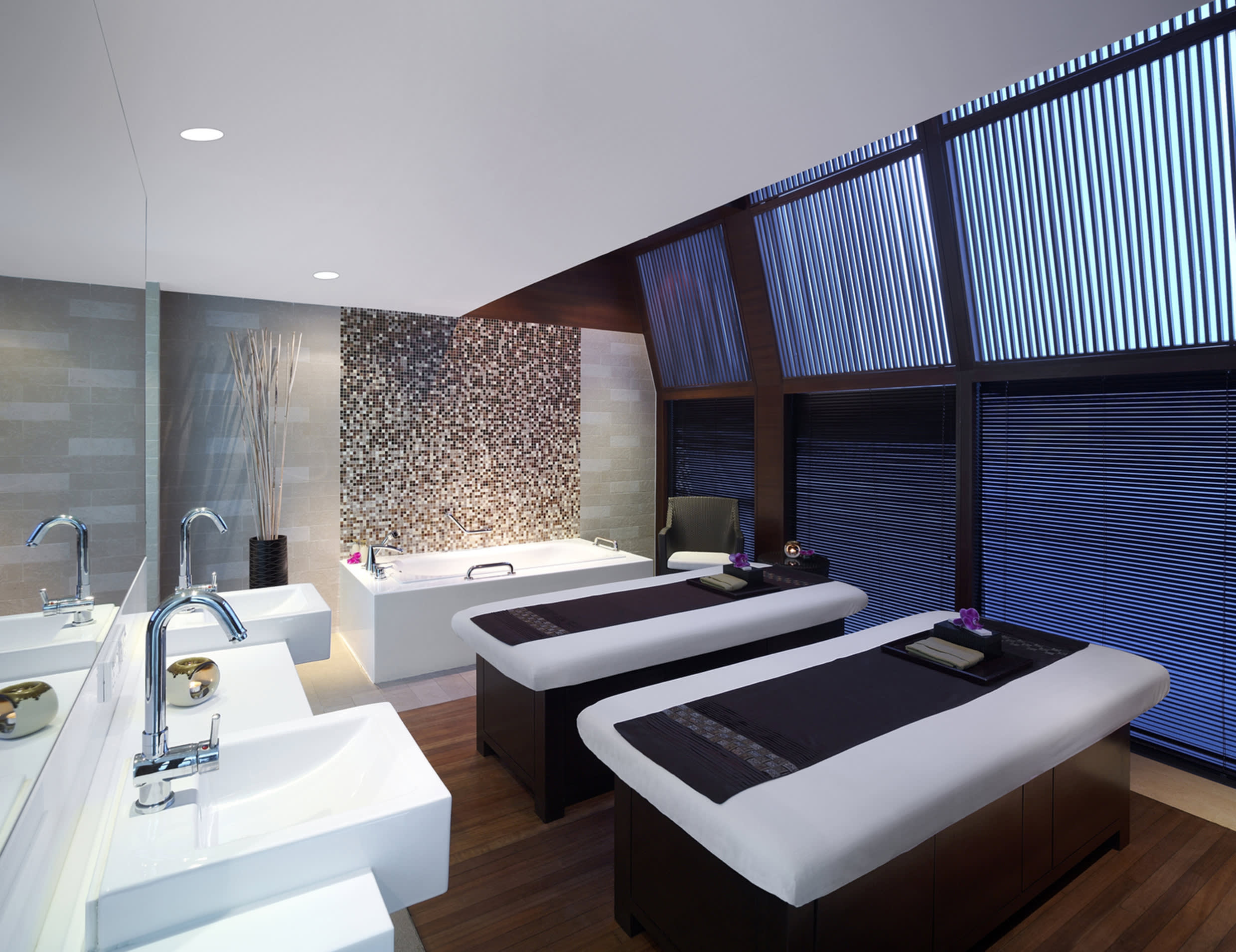 a large white bed sitting next to a window