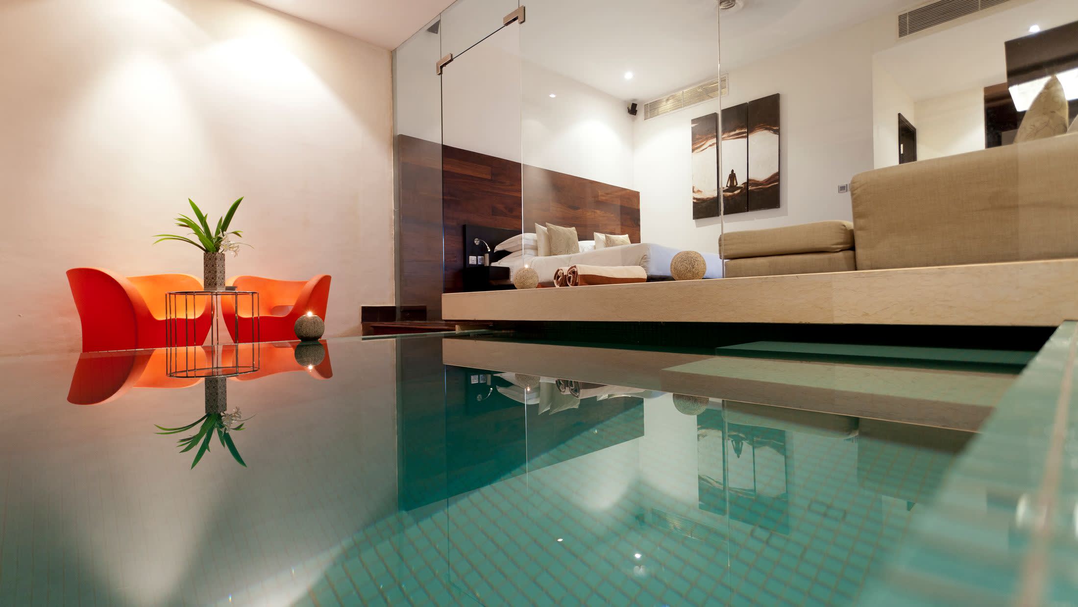 a room filled with furniture and vase of flowers on a table