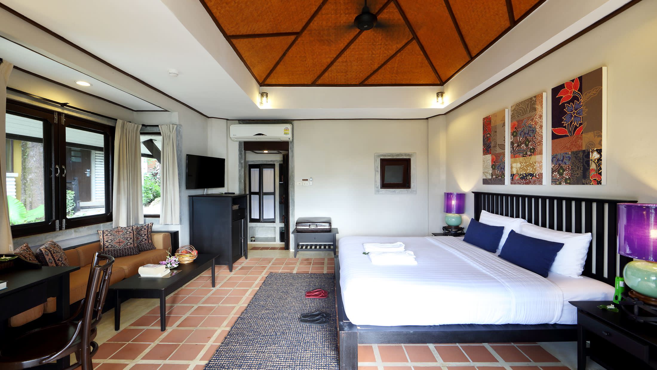 a hotel room filled with furniture and a flat screen tv