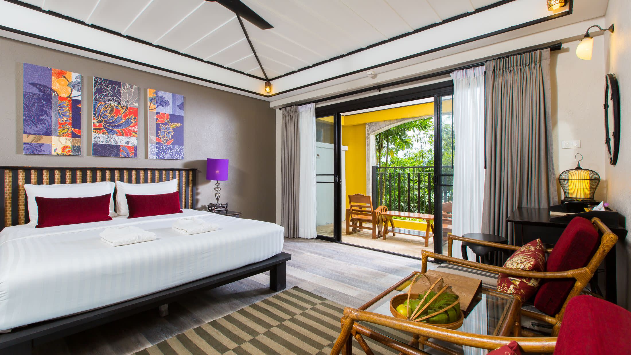 a bedroom with a bed and a chair in a room