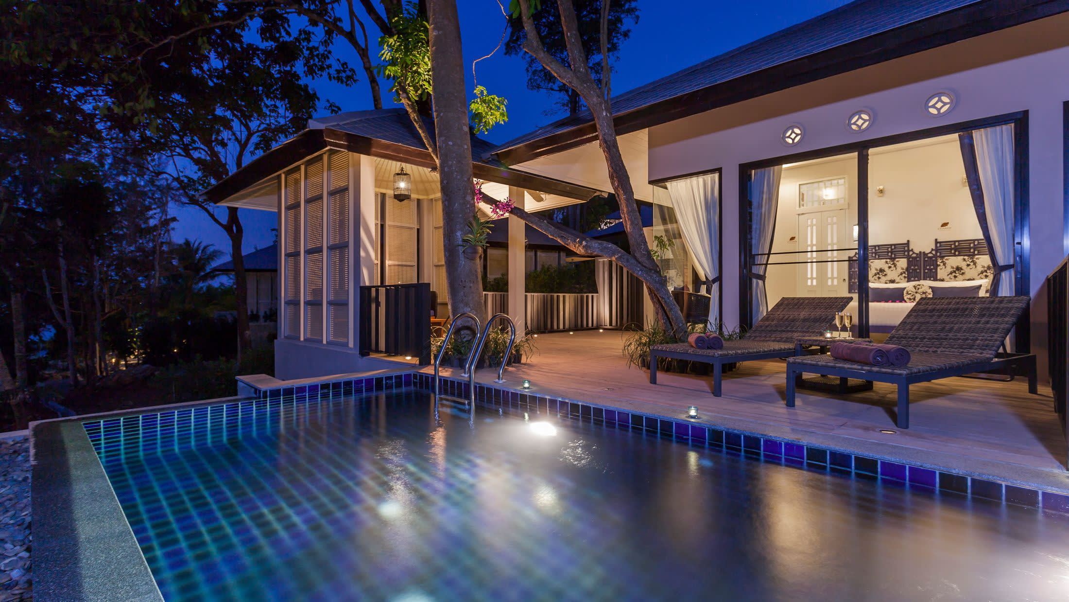 a house with a pool in front of a building