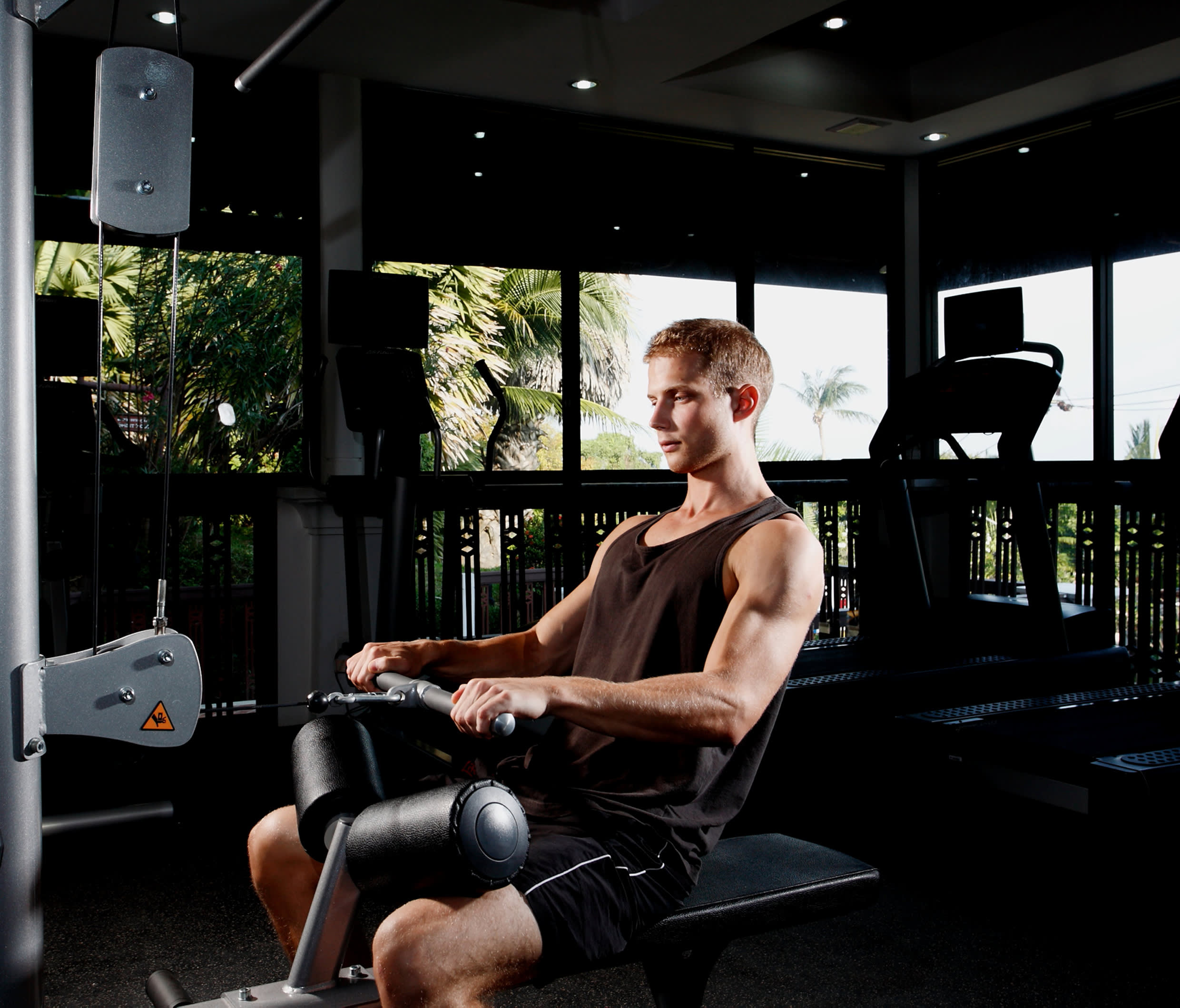a person sitting on a chair in front of a window