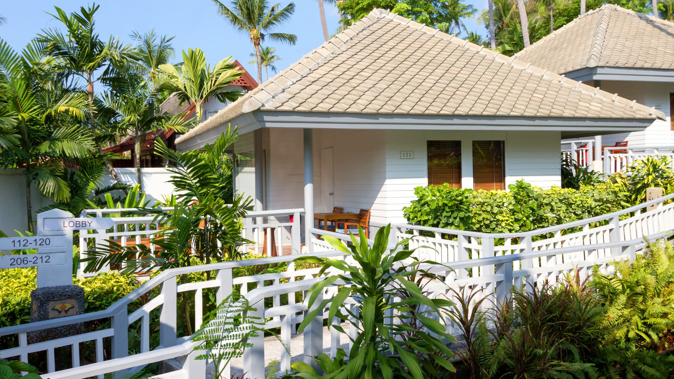 a house with bushes in front of a building