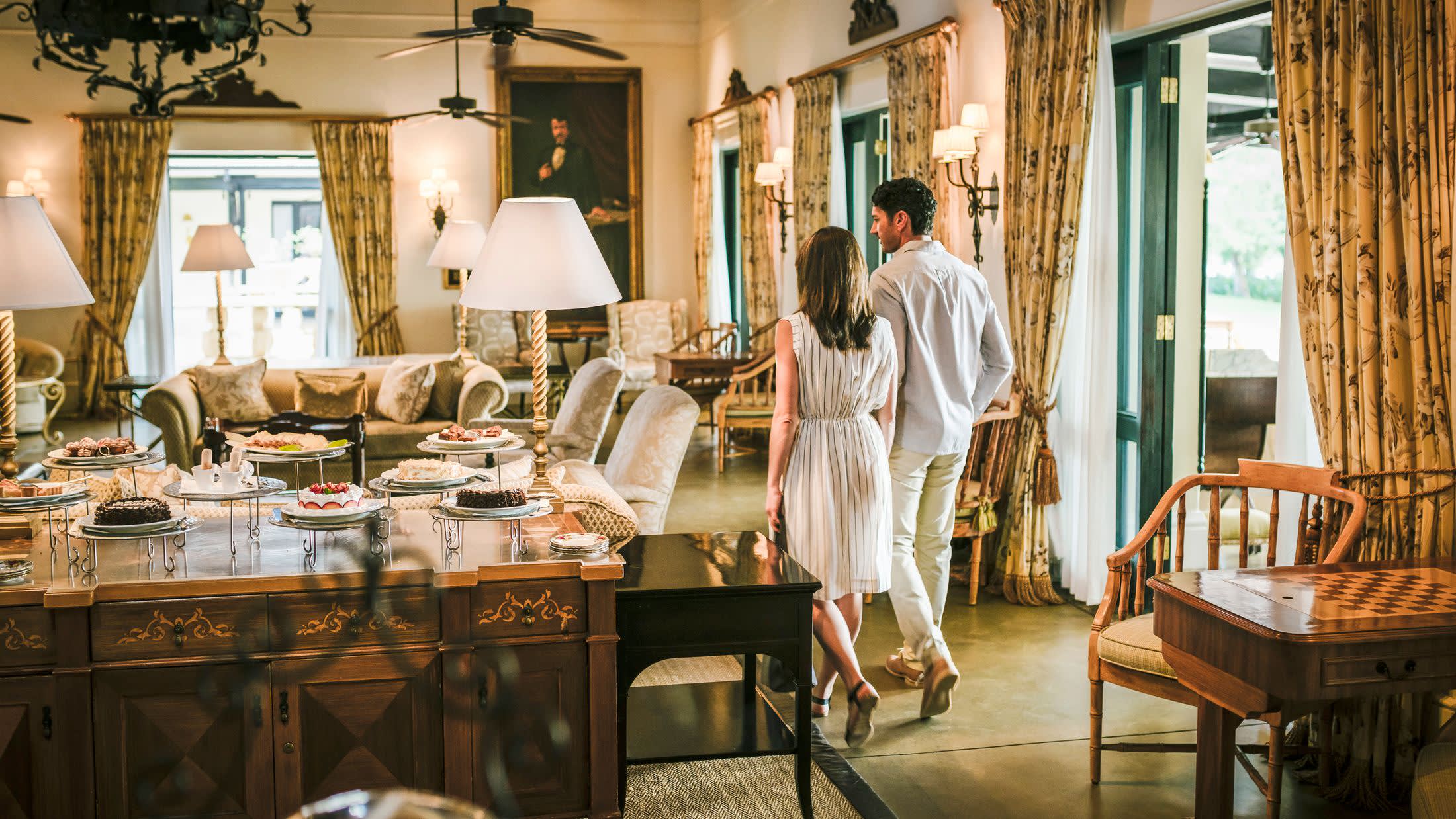 a living room filled with furniture and vase on a table