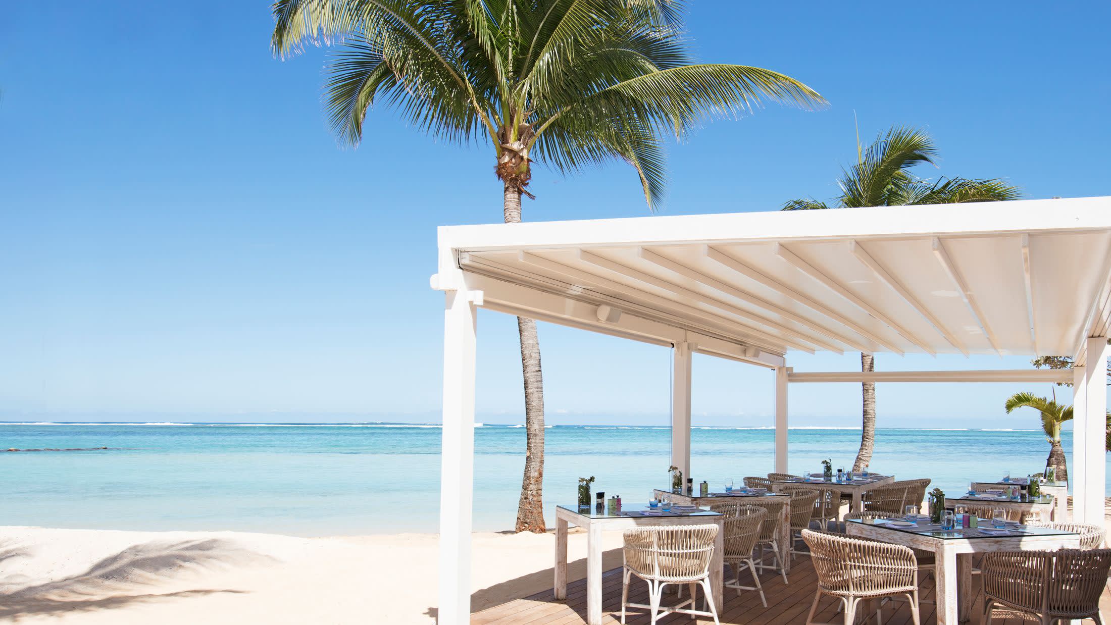 a couple of lawn chairs sitting on top of a beach