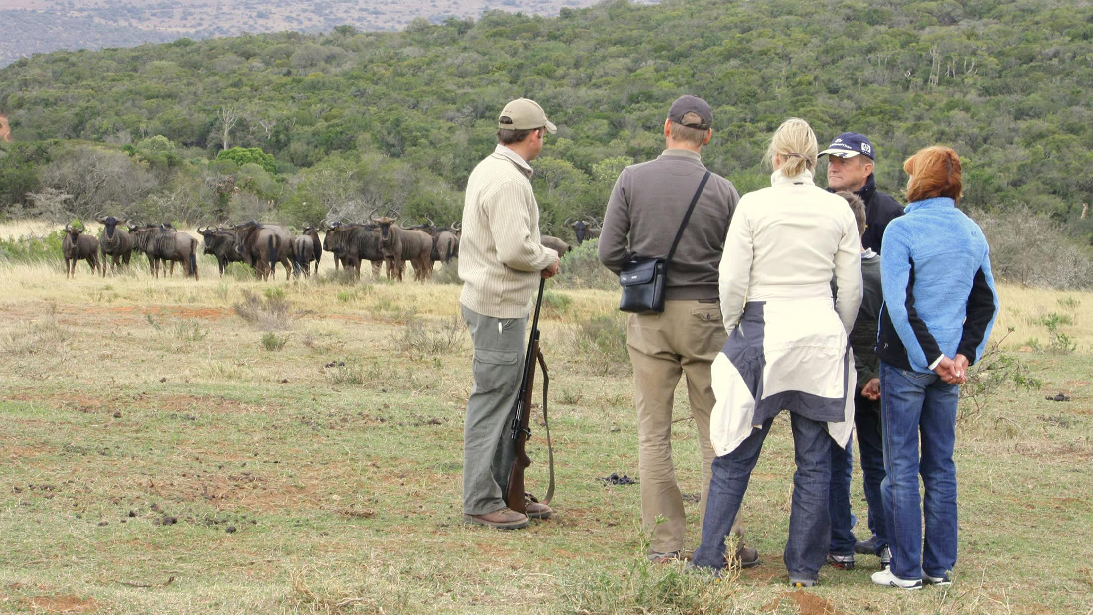 a group of people standing in a field
