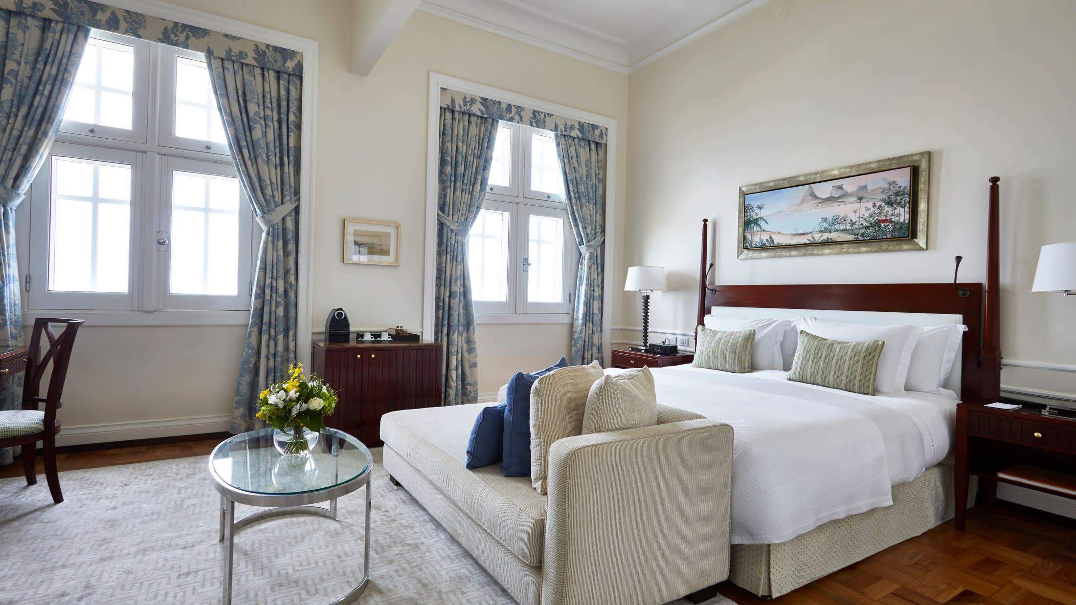 a bedroom with a bed and a chair in a room