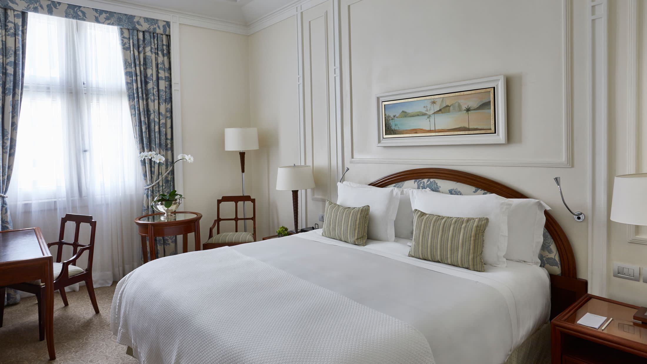 a bedroom with a bed and a chair in a room