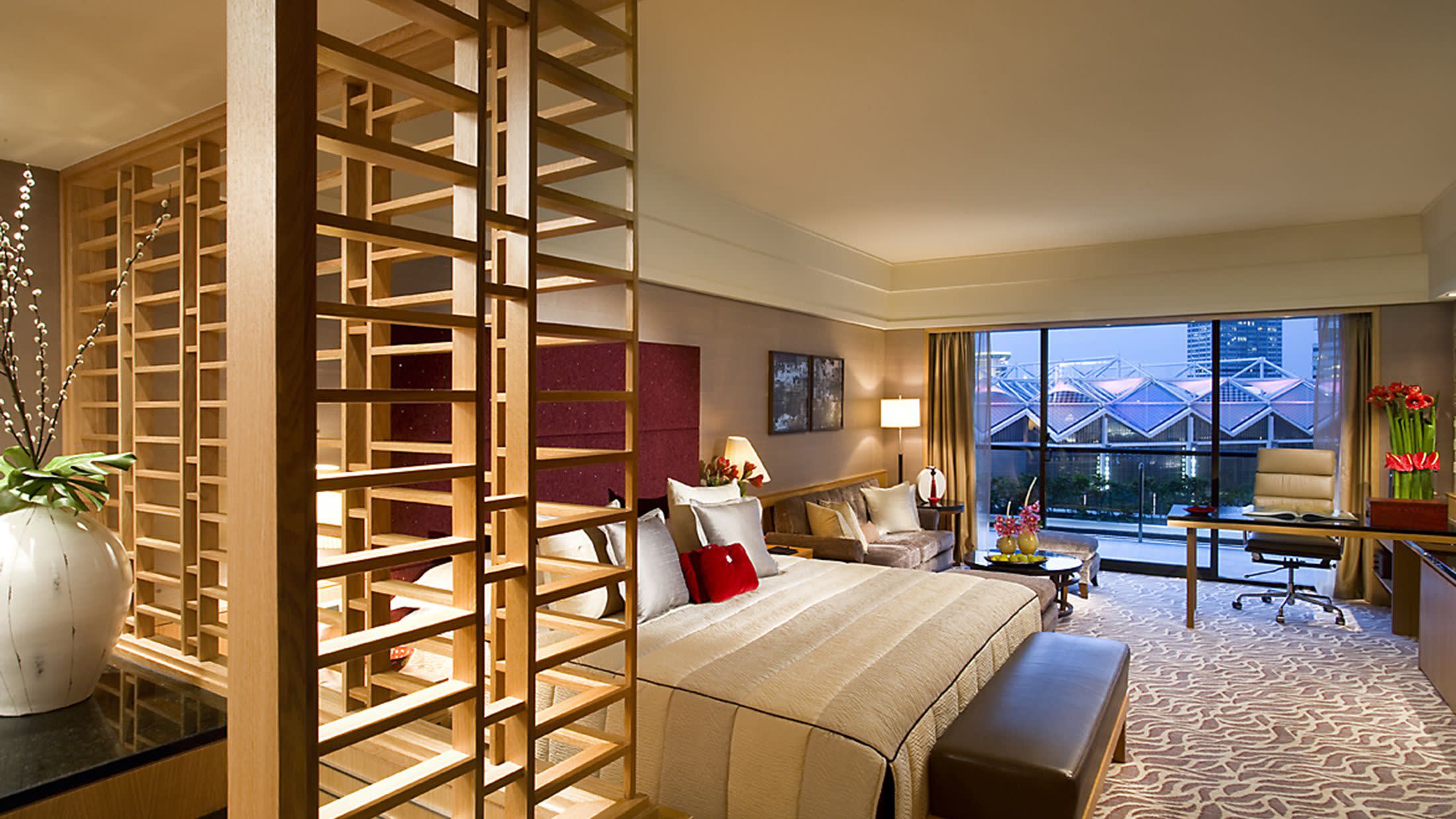 a bedroom with a bed and a chair in a room