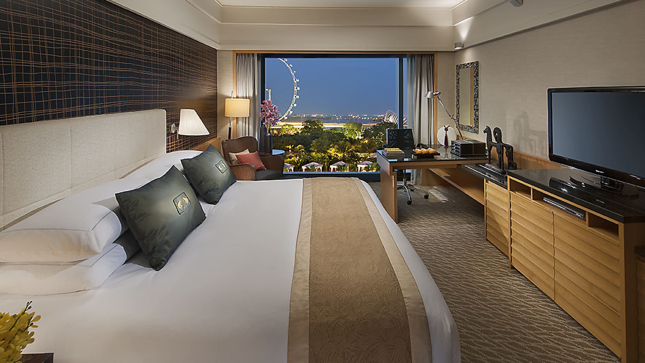 a hotel room with a bed and a flat screen tv