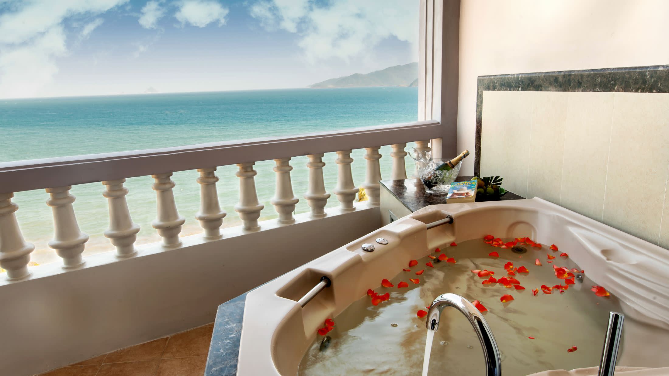 a large white tub sitting next to a window