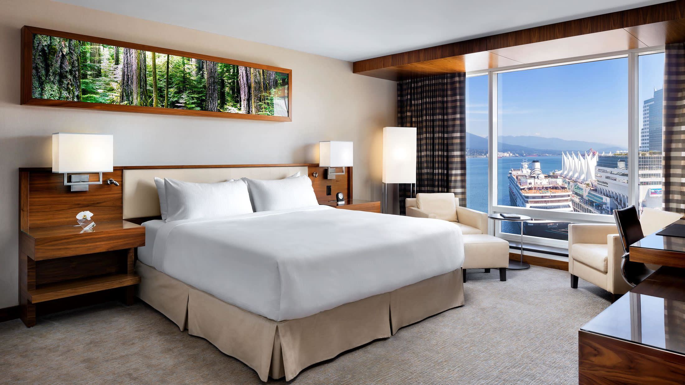 a bedroom with a bed and desk in a room