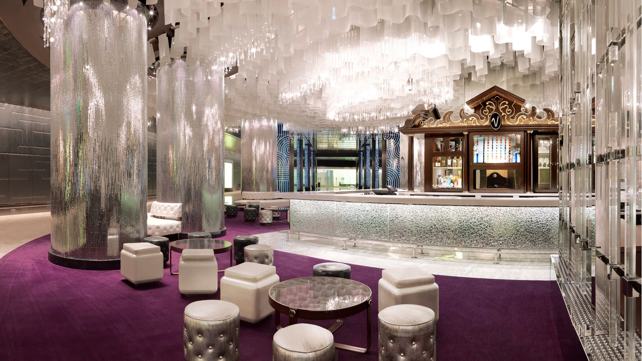 a room filled with furniture and vase of flowers on a table