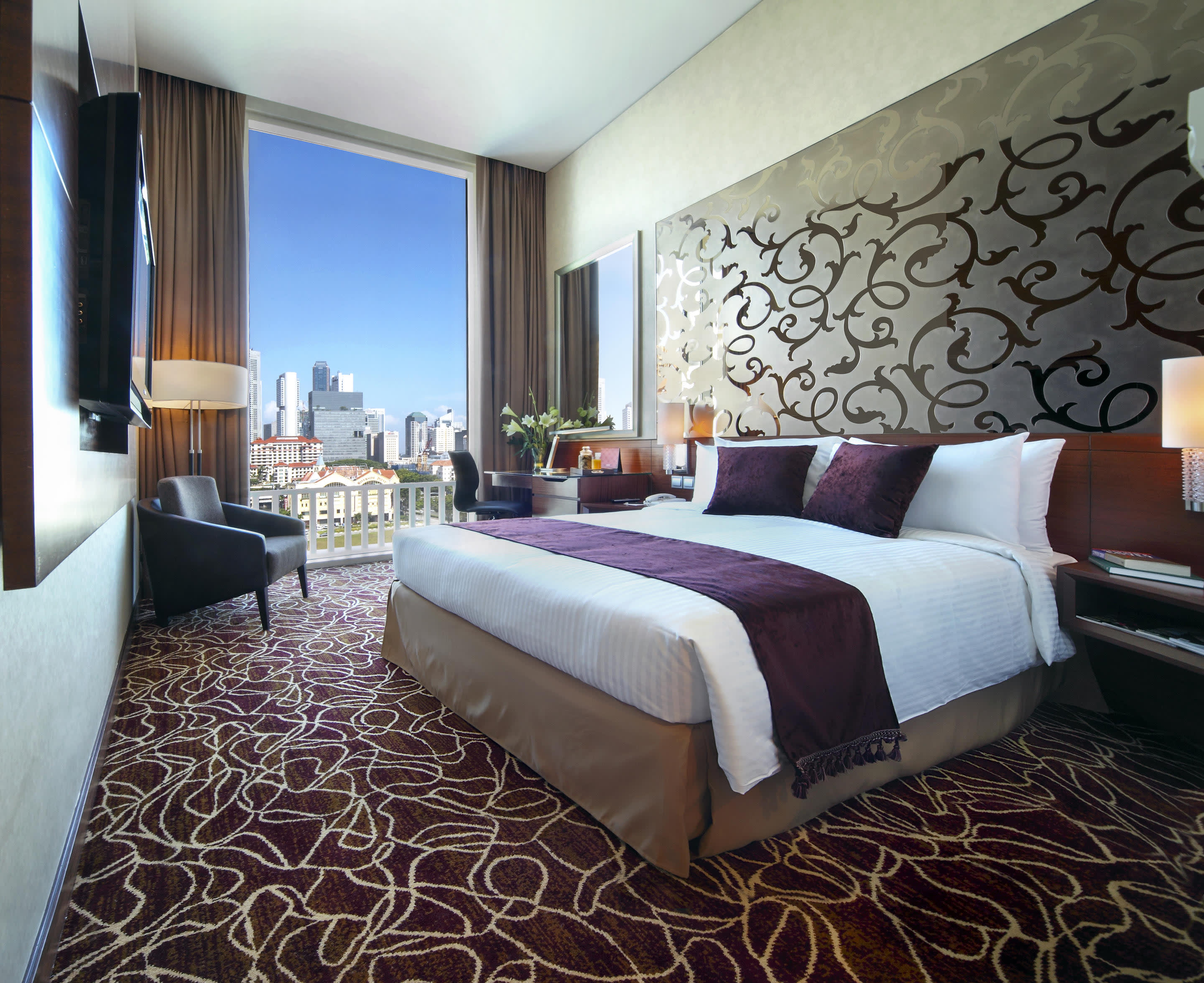 a bedroom with a large bed in a hotel room