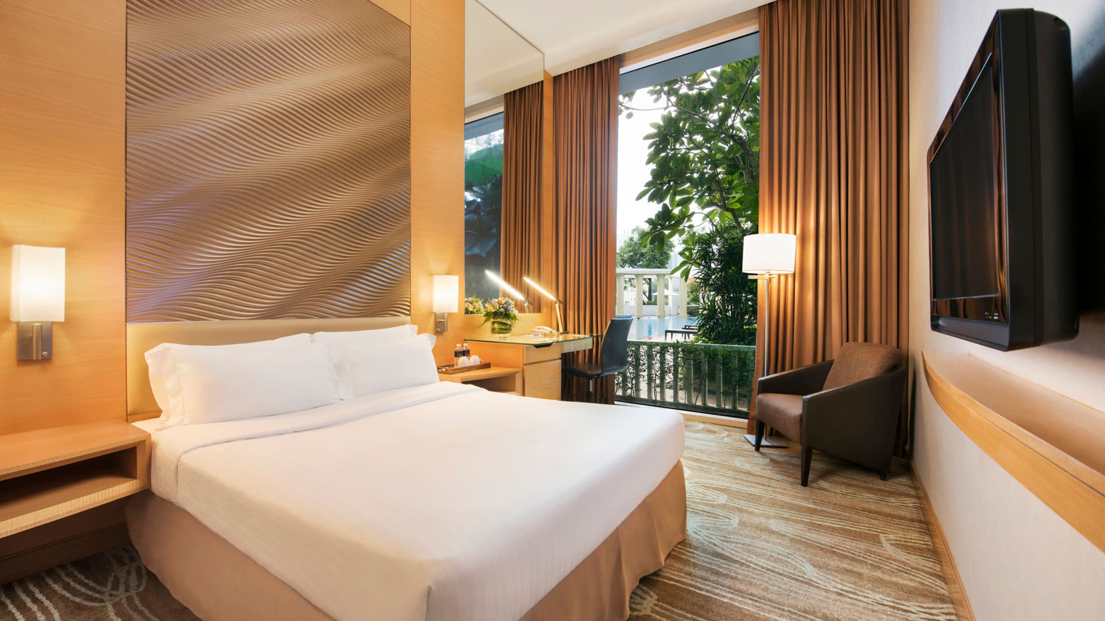 a bedroom with a large bed in a hotel room