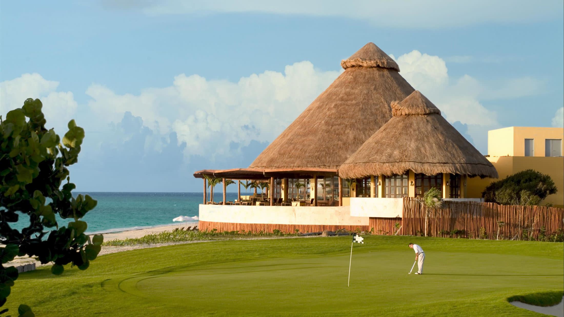 a large lawn in front of a body of water