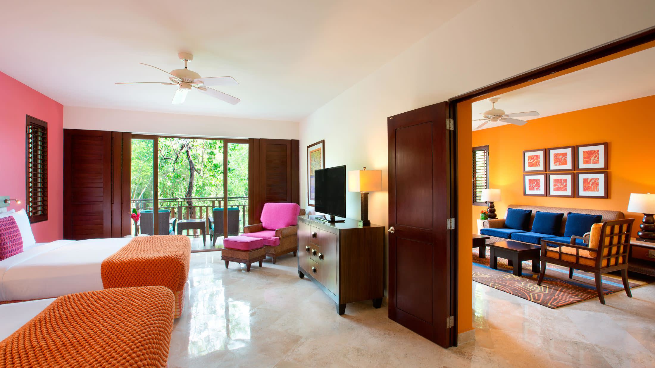 a living room filled with furniture and a bed in a bedroom