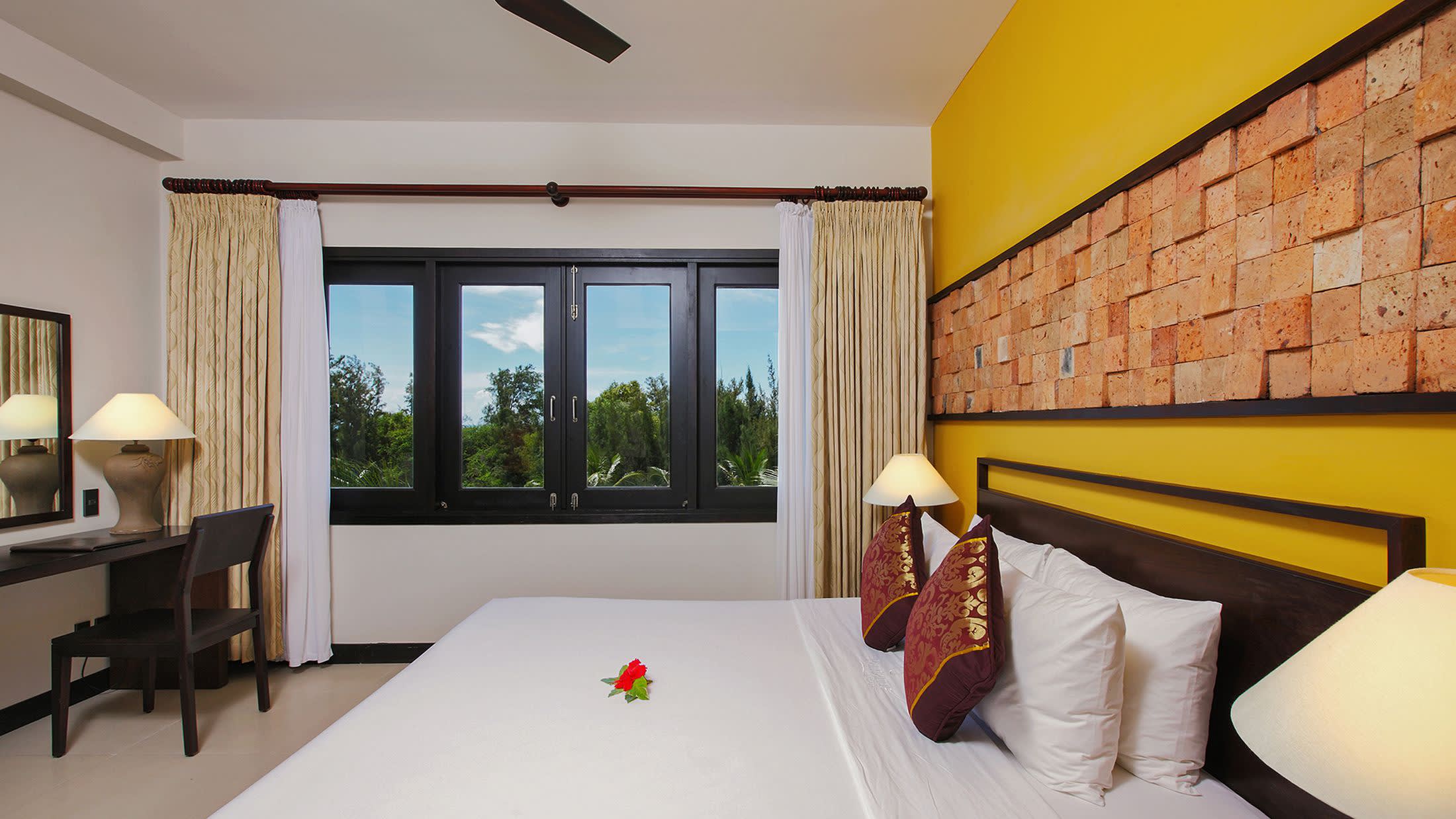 a bedroom with a bed in a room