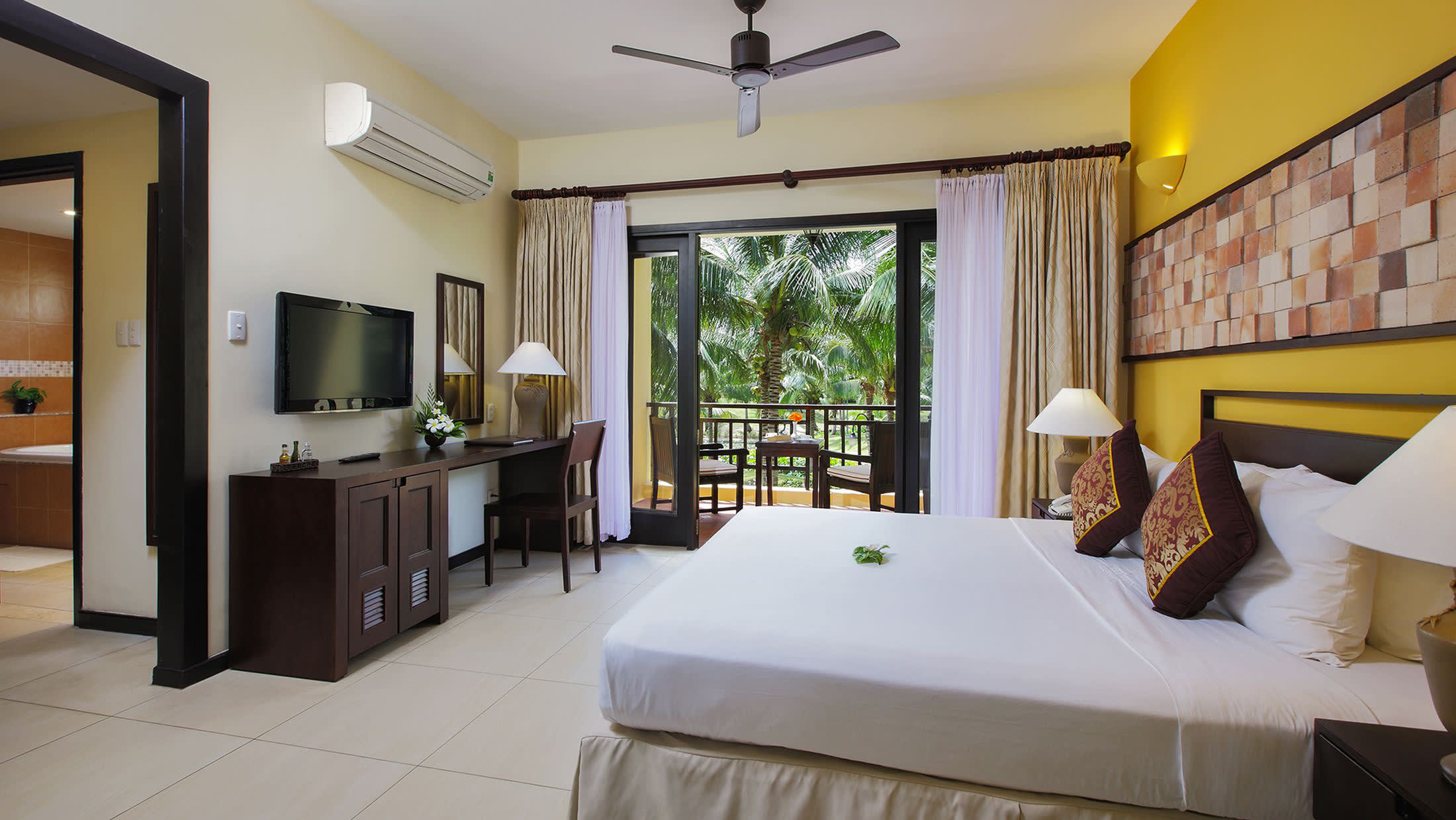a bedroom with a large bed in a hotel room