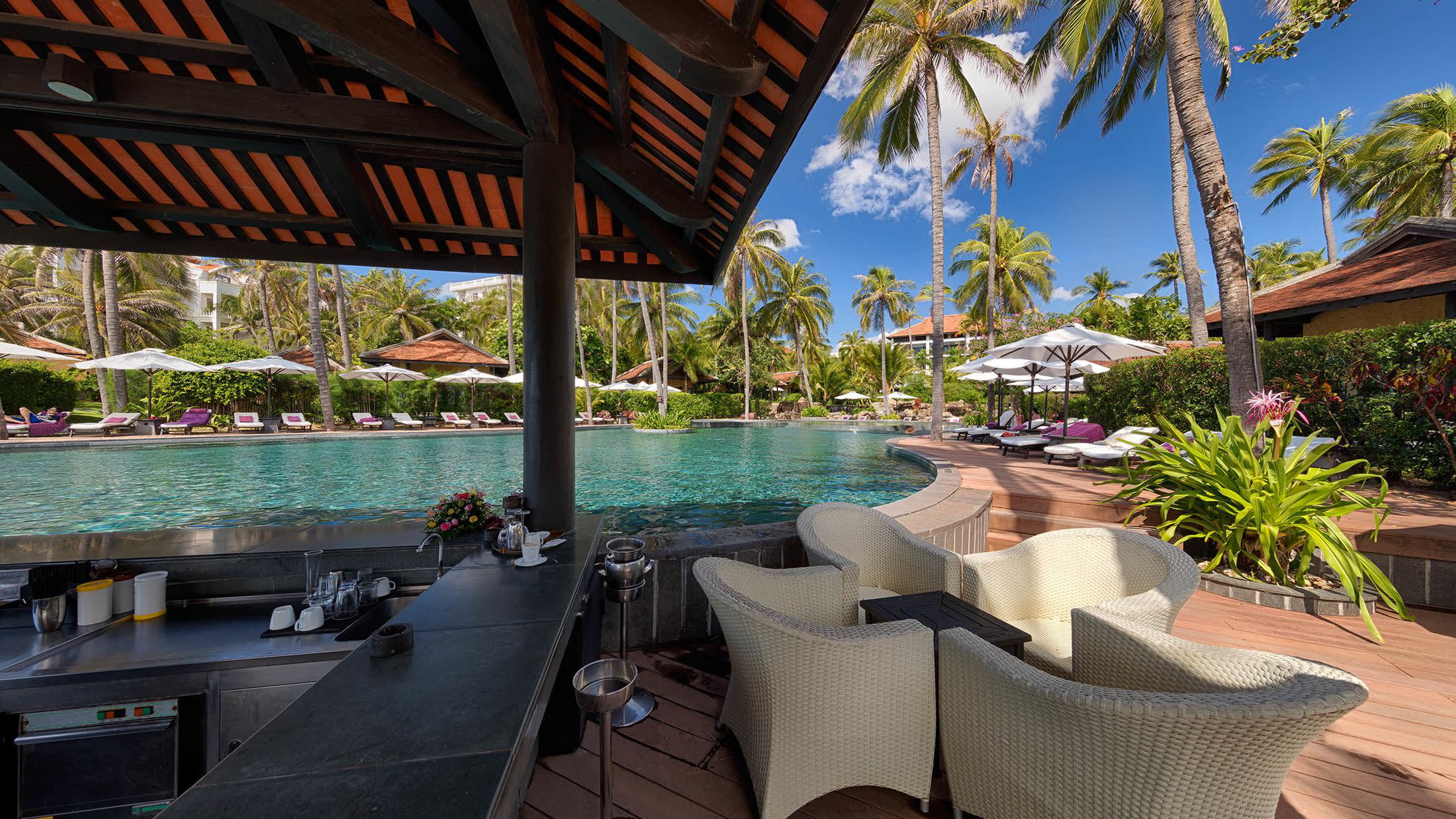 a pool next to a palm tree