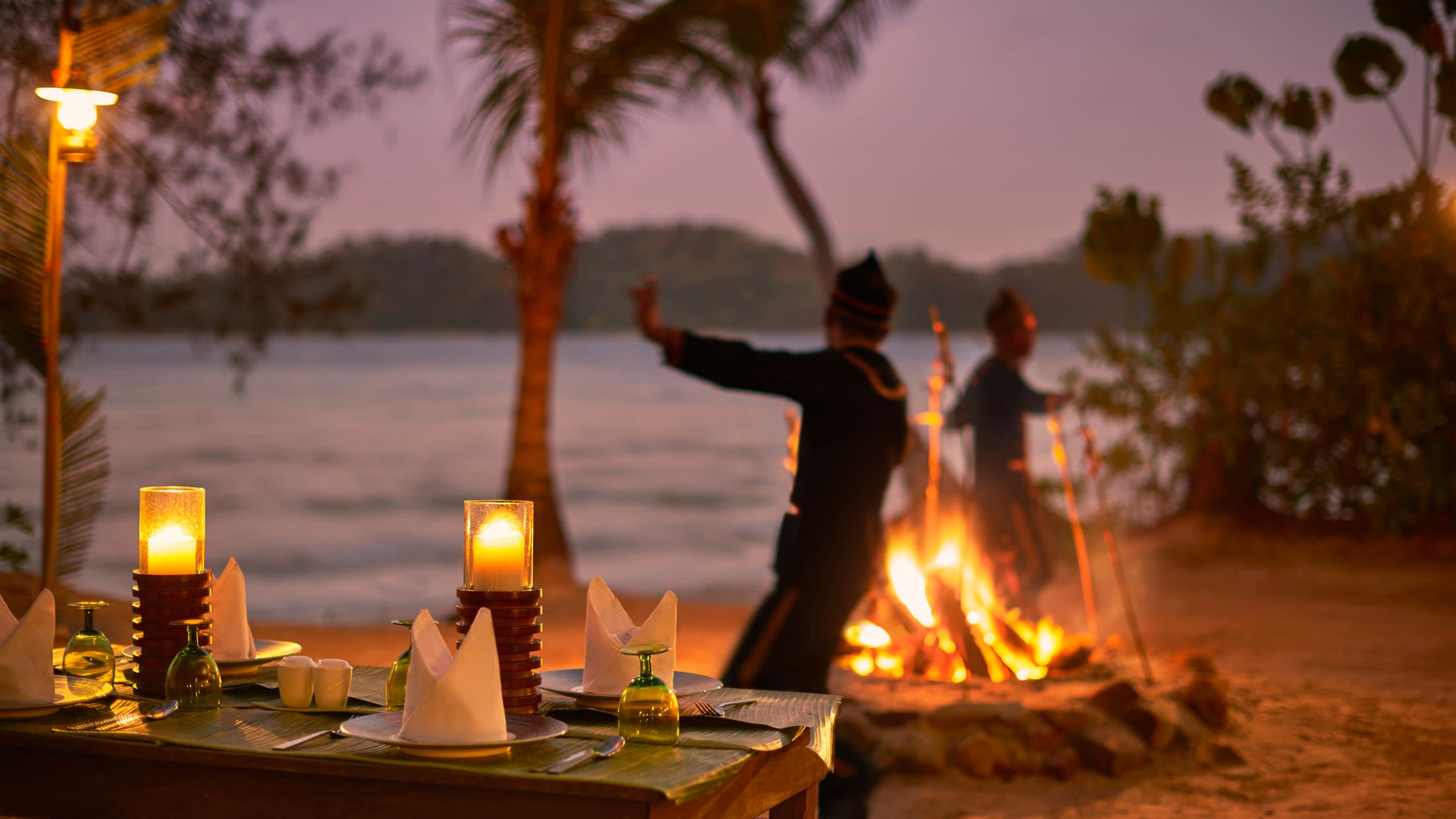 a group of people standing around a fire