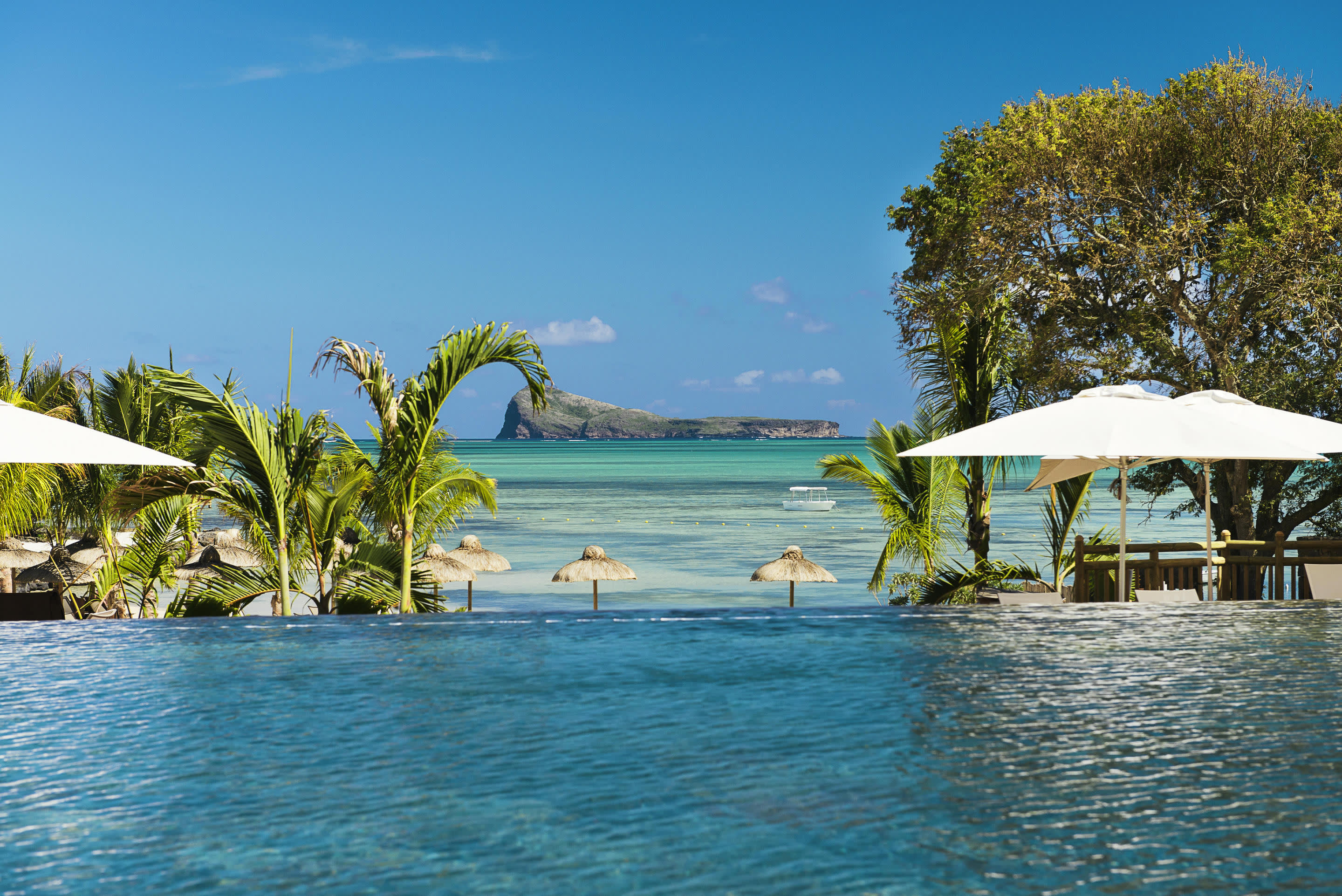a group of lawn chairs sitting on top of a body of water
