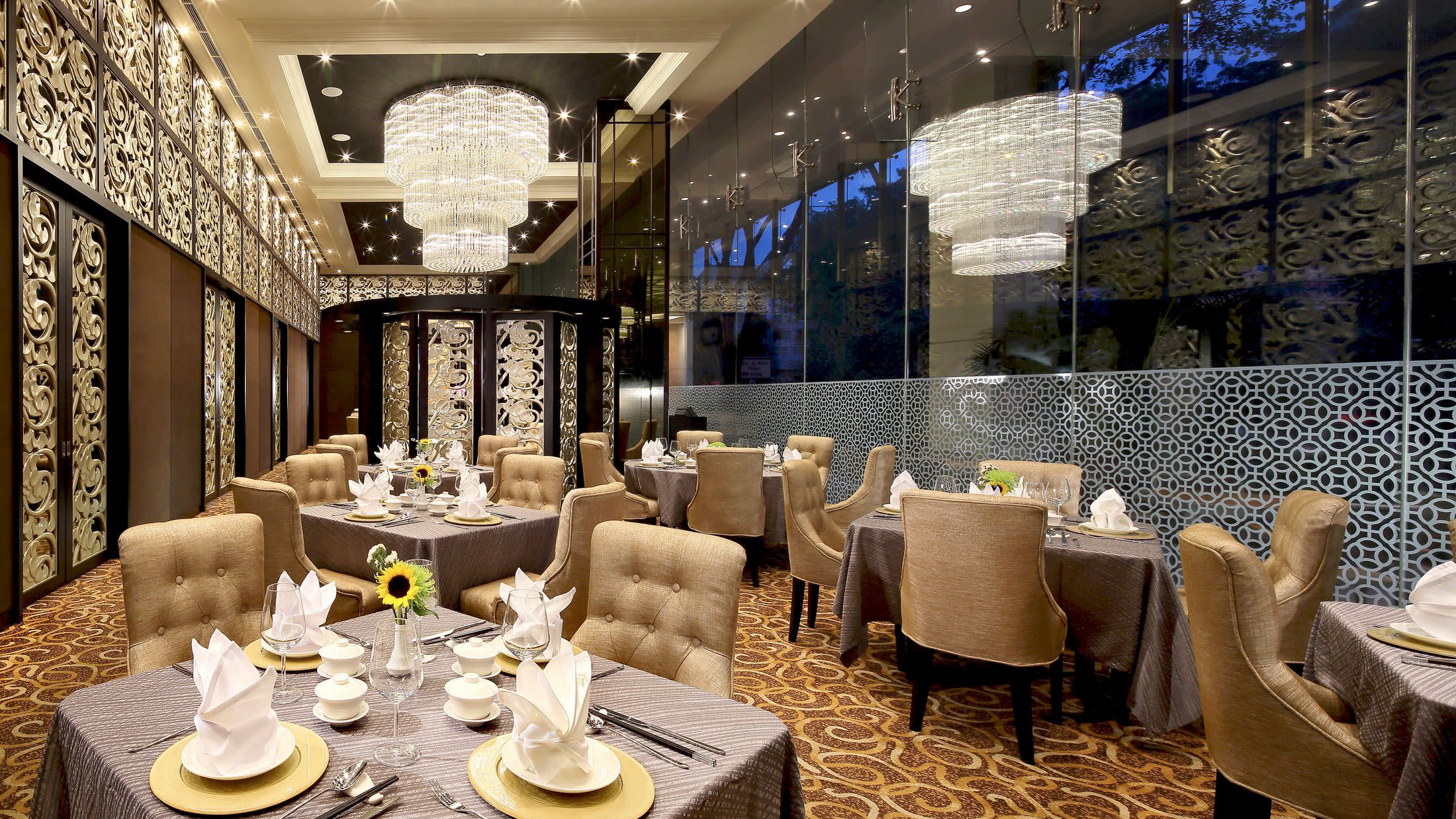 a room filled with furniture and vase of flowers on a table