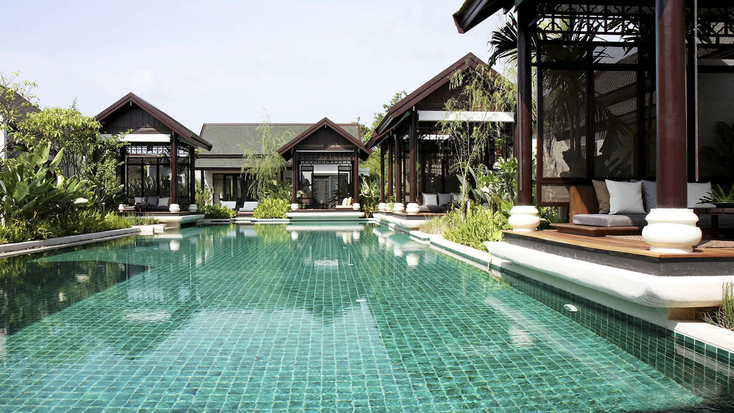 a house with a pool in front of a building