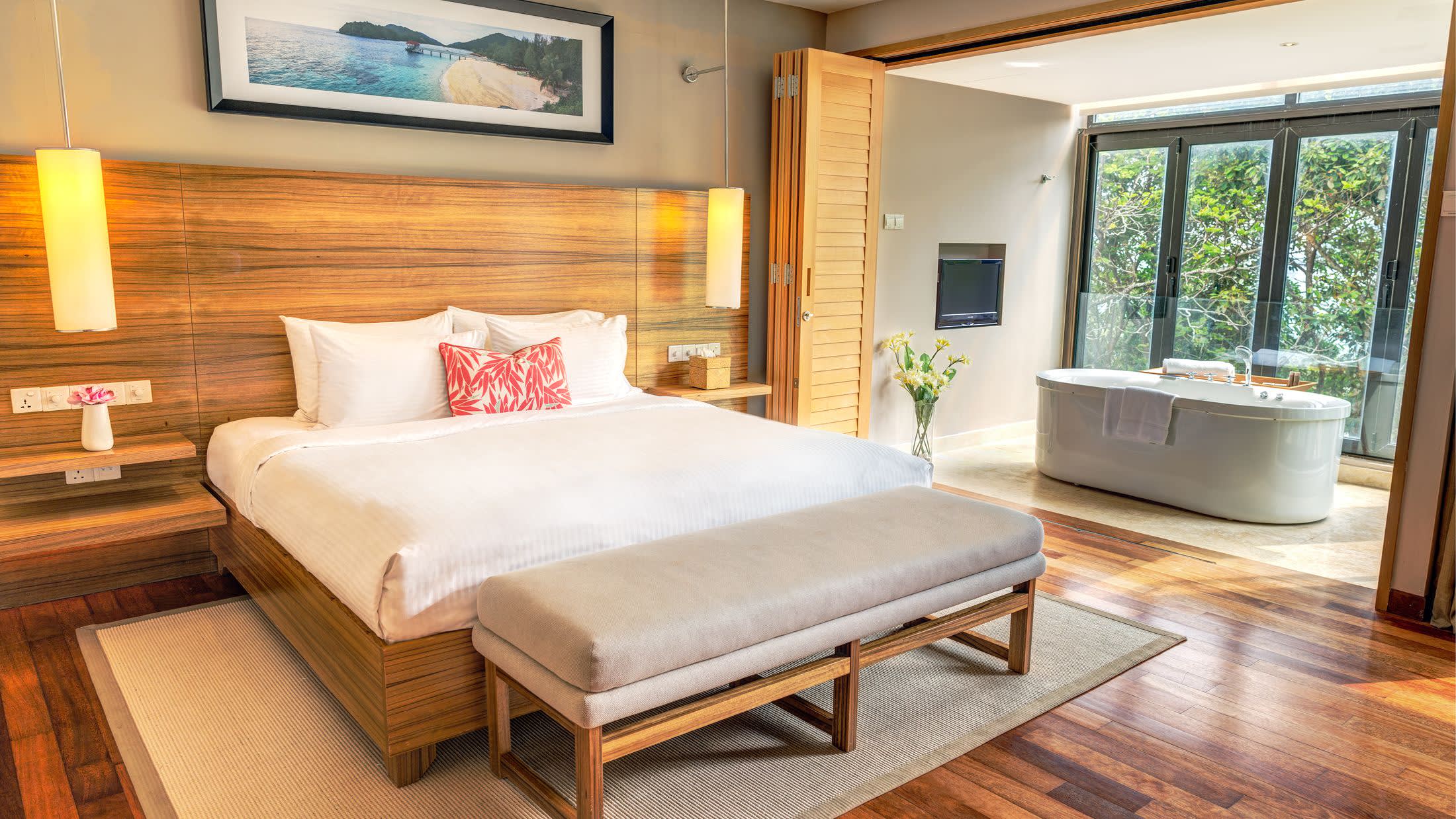 a bedroom with a bed and a chair in a room