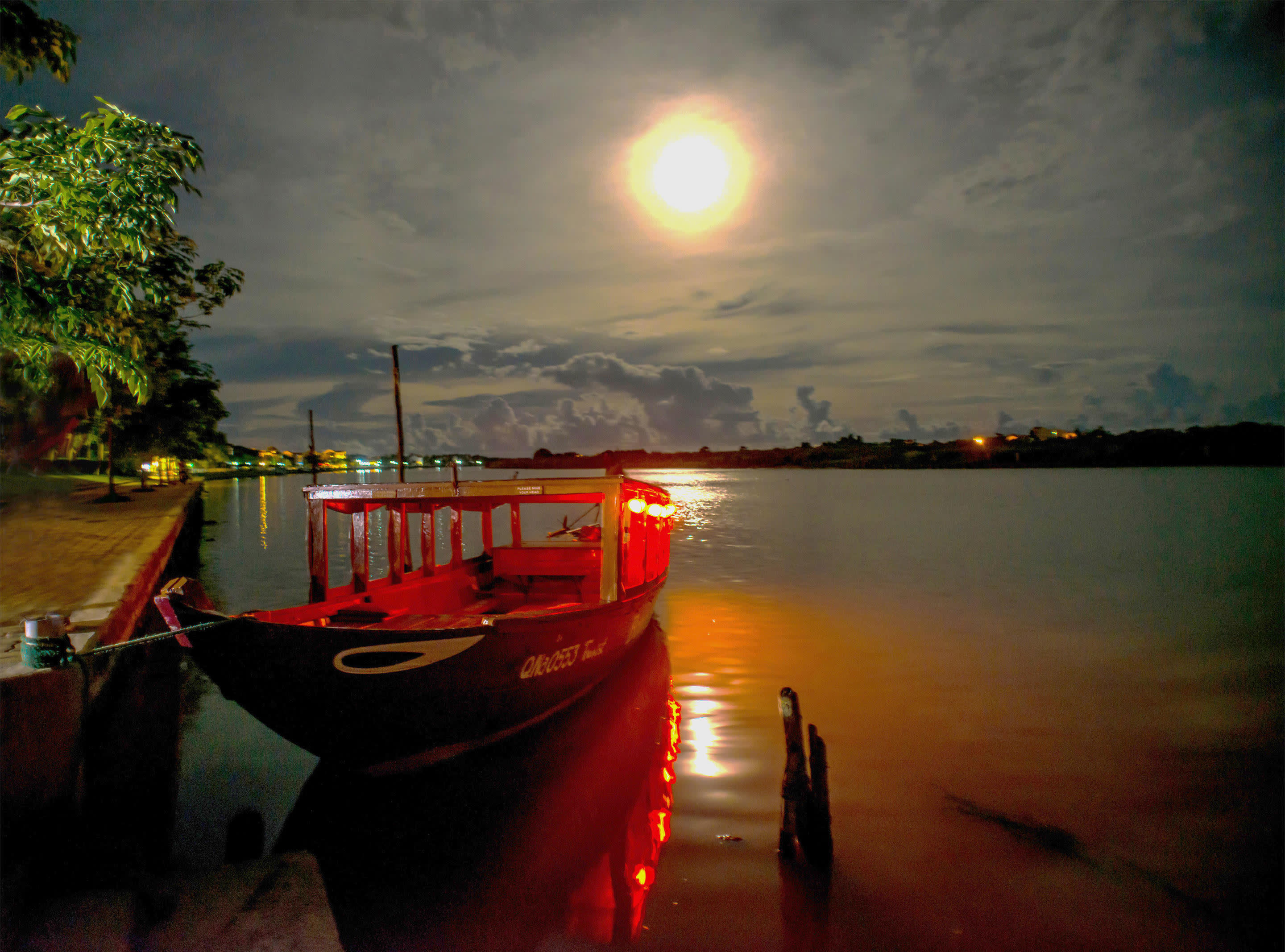 a boat is docked next to a body of water