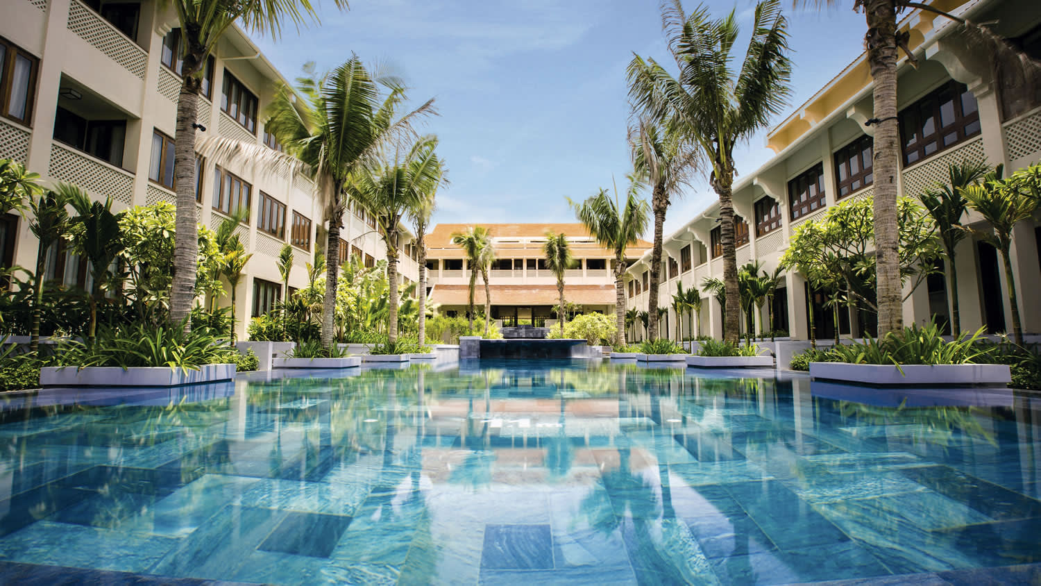a house with a pool in front of a building