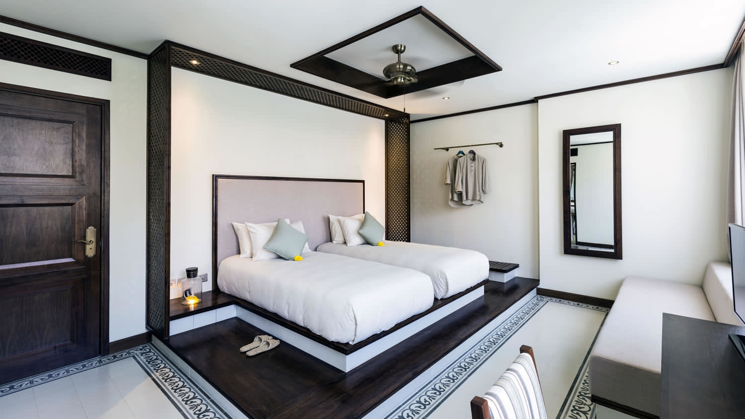 a bedroom with a bed and a mirror