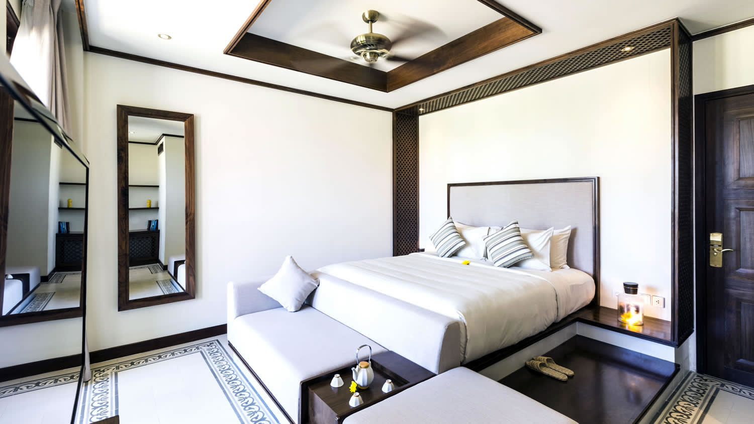 a bedroom with a bed and desk in a room